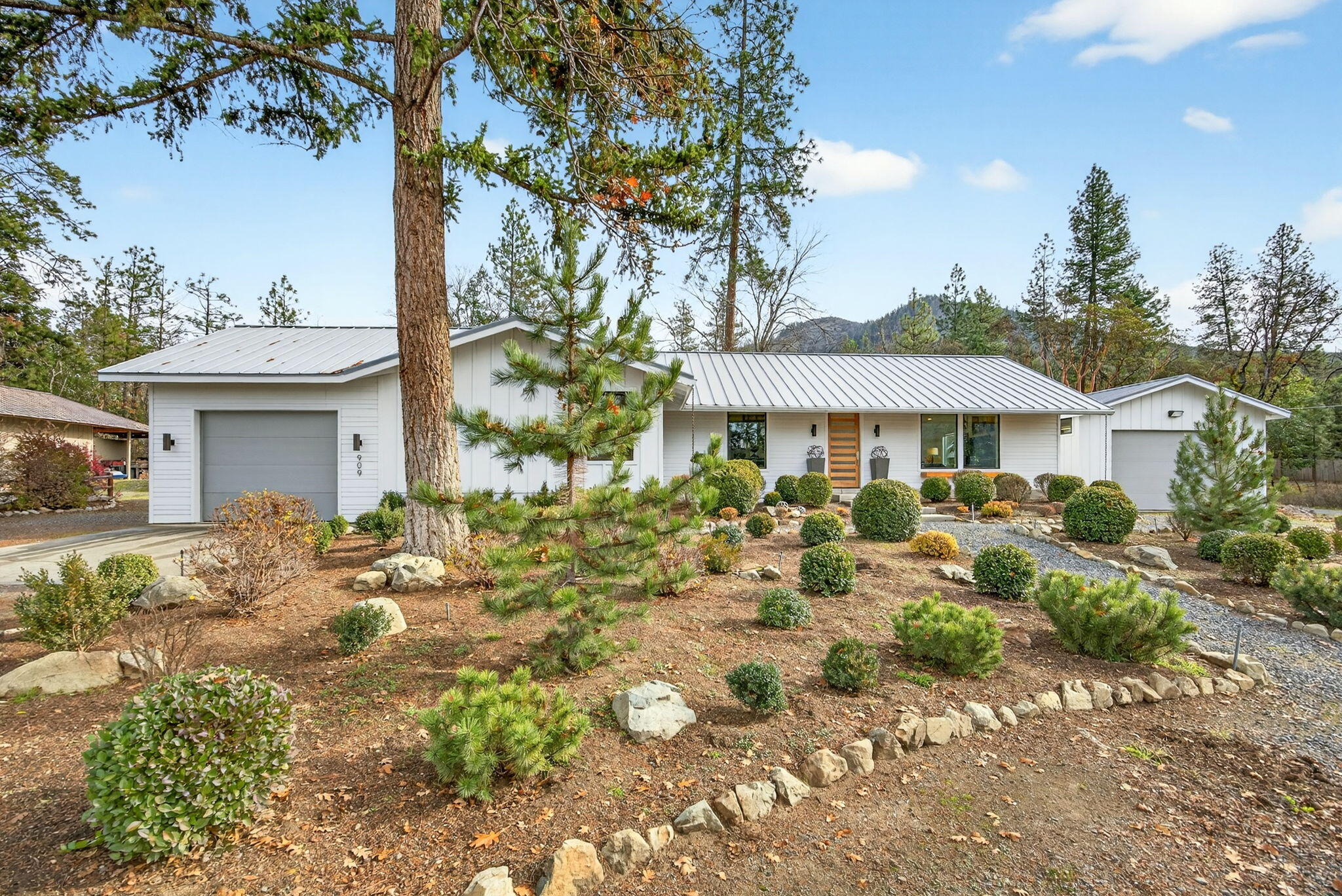 Fall in Love with this beautiful Modern Farmhouse. True to its 1976 character yet completely and extensively updated and remolded in 2019. This single-story home features 2 bedrooms each with an ensuite and a half bath with 2,052 sq ft sits on .47 acres. The prime location of being just 9 miles from historic down town Jacksonville and a minute from the Ruch Country Store, the hardware store and more. This charming home is move in ready complete with so many new updates including a roof, hvac system, electrical paneling, stone tile and carpeted flooring, quartz counter tops, wood burning stove, stainless steel appliances including a double oven, vaulted ceilings, huge picture windows throughout the home taking in the mountain views as well as the Valley View Winery vineyard directly across the street. This home also features an attached 1 car garage as well as a detached 2 car garage / shop. Beautifully landscaped front and back. This home is a must tour in person.