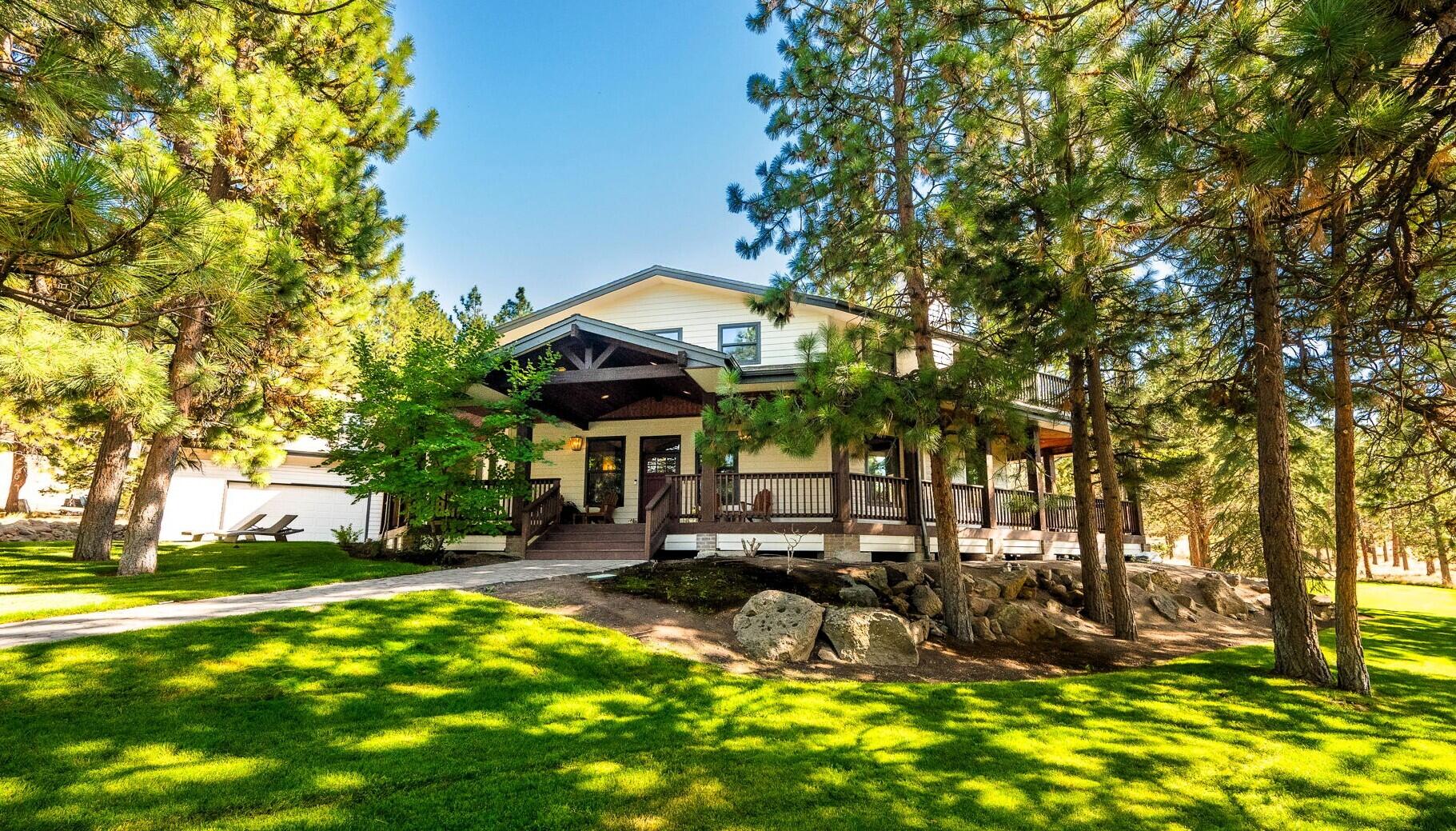 Picture your family's next chapter unfolding here. Beautifully remodeled from top to bottom, this turn-key and rare Awbrey Butte home sits on nearly an acre of park-like grounds—offering privacy, play, and peaceful retreat among the trees. Inside, high ceilings and expansive new windows showcase a complete remodel that creates warm and welcoming spaces throughout. The flexible 4BR layout includes main-level great room, office/media room, and full bath, plus upstairs bonus and theater rooms—perfect for kids, hobbies, or guests. At its heart, this is a true gathering place with an impressive kitchen flowing to both the private back patio and wraparound deck with spaces to entertain, relax, and build lasting memories. Premium touches include private sauna, hot tub, heated 4-car garage & driveway, plus secluded primary balcony. Minutes from parks, trails, and downtown yet worlds away, this thoughtfully designed home blends peaceful sanctuary with the joy of bringing people together.