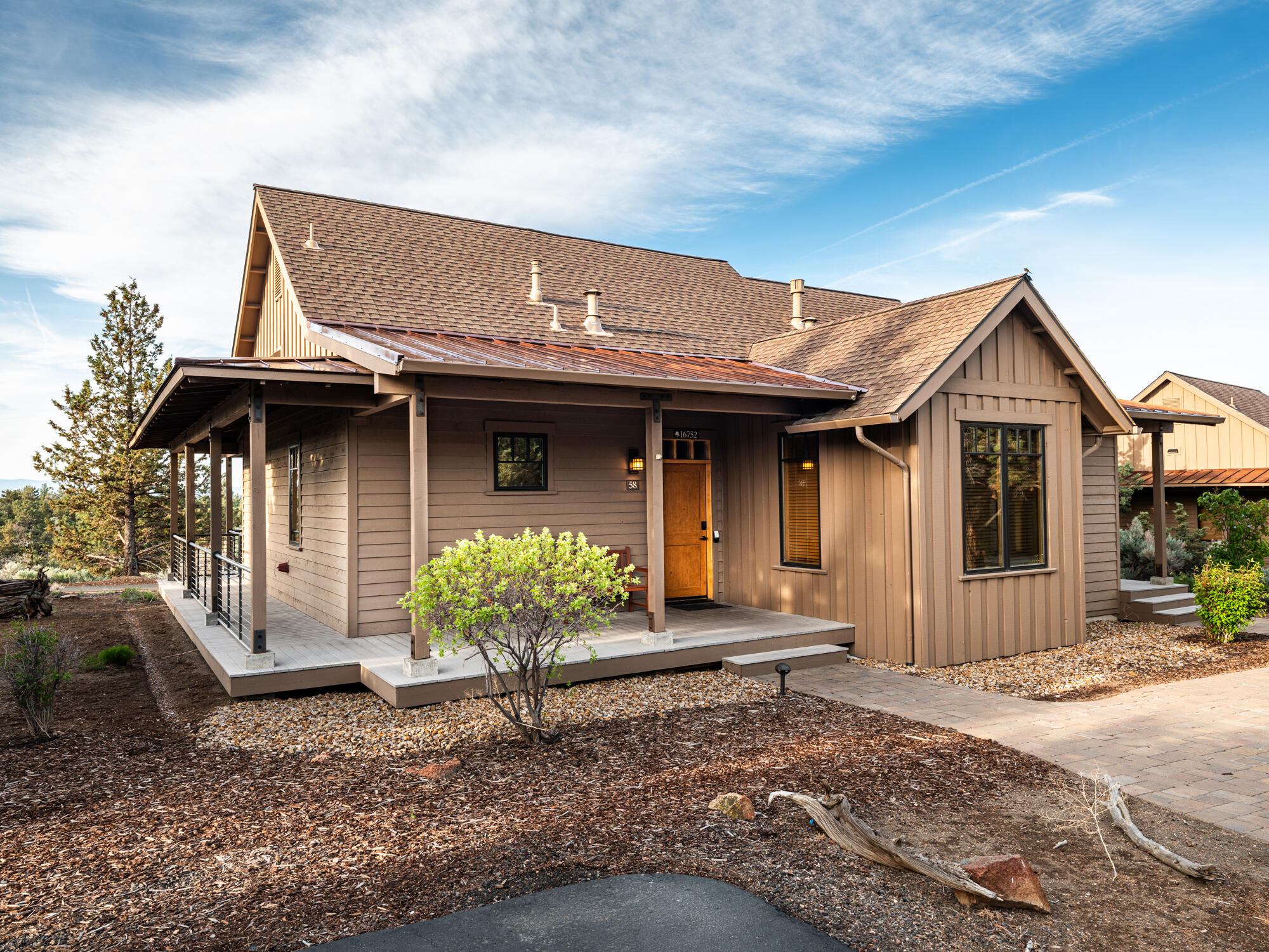Nestled at beautiful Brasada Ranch by hole 9 of the Brasada Canyons course, this charming 2-bed, 2-bath single-level cabin offers treed privacy and rustic elegance. Featuring hardwood floors, a stone fireplace, rustic finishes, and a full kitchen with stainless steel appliances, granite countertops, a peninsula bar, and an eating area. The second suite can be locked off, equipped with a fireplace, mini fridge, coffee maker, and microwave. Enjoy stunning sunsets from the wrap-around porch with a private hot tub and an enclosed gate area—perfect for pets or kids. Brasada's luxurious amenities include pools, a gym, restaurants, a spa, golf, trails, horseback riding, seasonal events, and kid-friendly fun. Whether seeking a relaxing retreat or an activity-filled getaway, adventure and serenity await!
