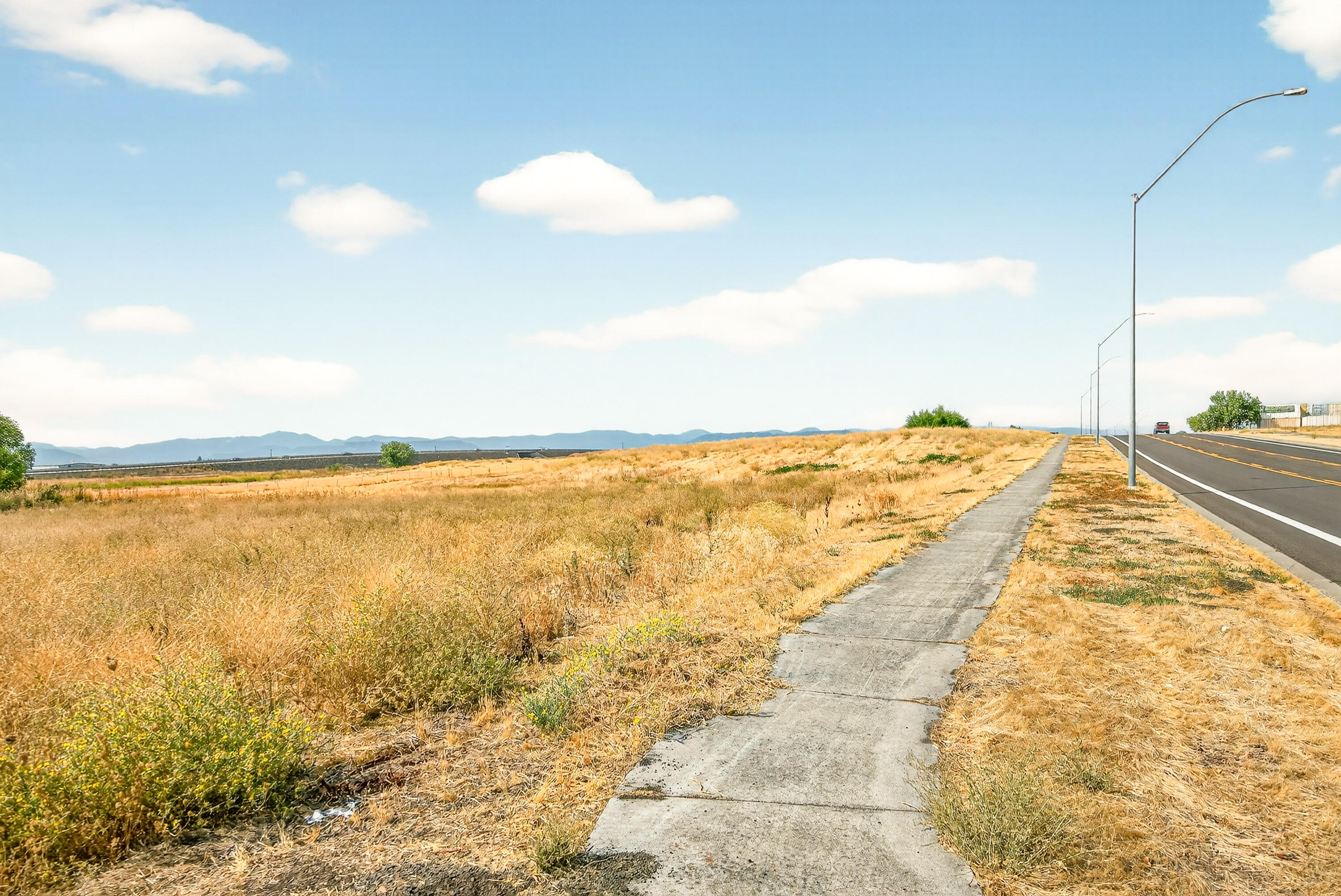This prime Light Industrial parcel offers endless possibilities, just 2.5 miles from the Medford Airport and Interstate 5, and minutes from shopping, dining, and major retailers, including Costco, Walmart and Amazon warehouse. Zoning allows for a wide range of uses—such as business offices, manufacturing, warehousing, and even farming (see attached document for full list). Utilities are available to the lot; capped well on-site. An adjacent 1.68-acre parcel, Tax Lot 901 (MLS #220208327), is also available, offering an excellent opportunity for expansion or development flexibility.
