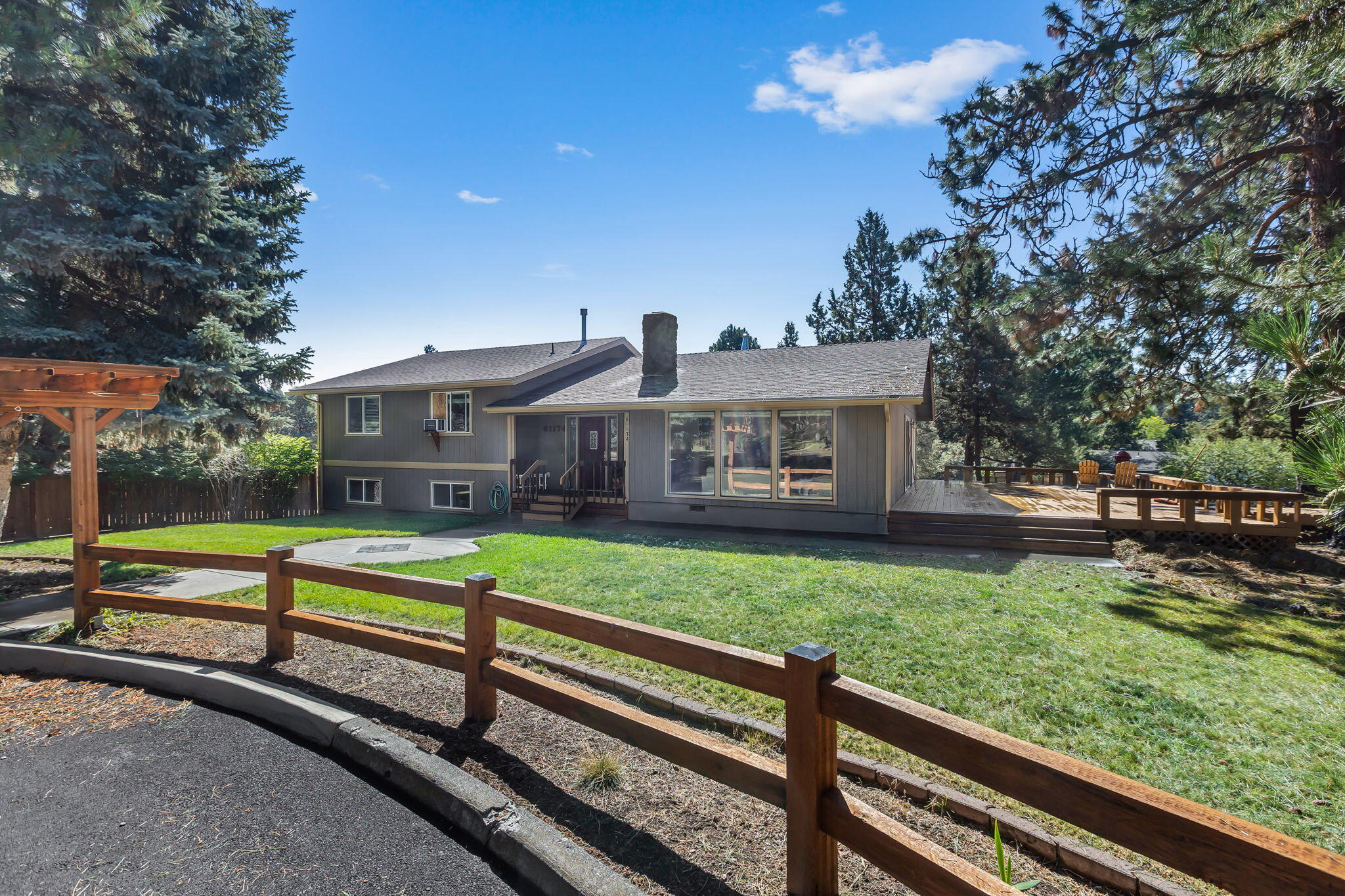 Welcome to this charming 1977 home in SE Bend boasting 1936 sf of character and comfort. This updated 3 bedroom, 2 bathroom gem features stunning tongue-and-groove vaulted ceilings that add character and ambiance. Enjoy abundant natural light from the large  picture windows and relax in the serene setting provided by the mature trees surrounding the property. The expansive deck and RV parking add convenience for all your hobbies and storage needs. Don't miss out on this unique blend of character and modern updates. Permits granted and paid for to connect to city sewer. Connection to be completed prior to closing. Shed included. Lot provides opportunity for an ADU/SHOP, etc. Buyer to do due diligence with City of Bend. Newer appliances, HOT TUB included in AS-IS condition (works well, 5 yrs young). Roats Water. Exterior paint 2018. Wood fireplace cleaned July, 2025. Furnace is older and in great condition - serviced and inspected July 2025. Newer H20 heater.