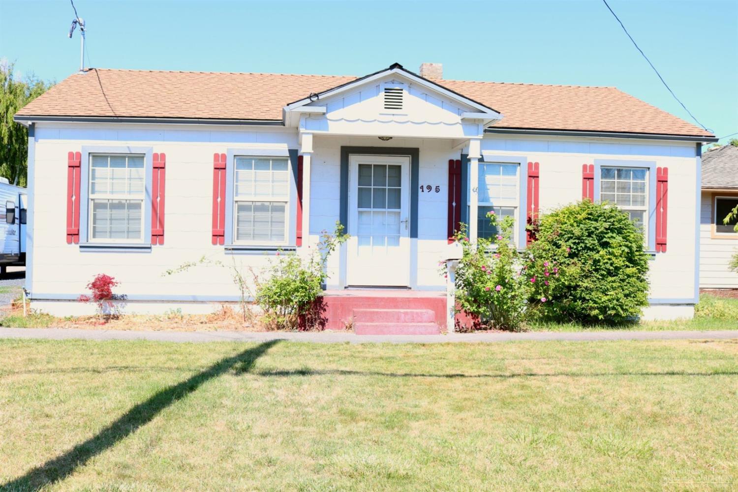 Cute Cottage style home set in Prineville's city corridor. Daylight style finished basement has laundry area. Appliances in the home included. Yesteryear charm throughout the home includes, wainscoting, arched entry to kitchen, hardwood flooring in living area, characteristic cabinetry, mature landscaping, fruit trees in the fenced back yard. Separate garden area, covered patio for year round use. Larger detached garage has storage room. Fantastic starter home or investment opportunity
