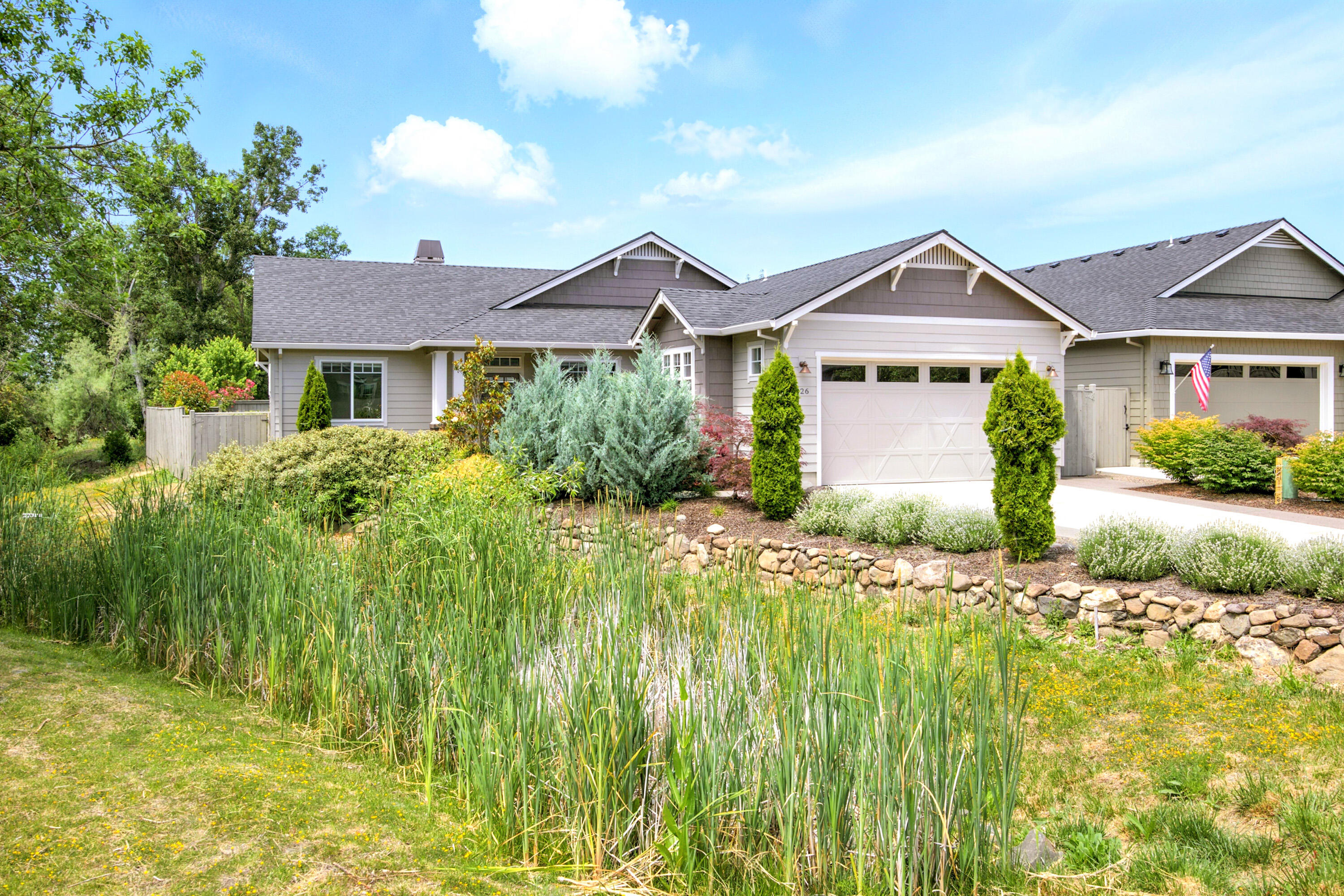 Quality built single-level home with an exceptionally convenient location in East Medford. Approx. 1766 SF + 2-car attached garage built in 2020, on .15 of an acre lot. A well-designed floor plan has the primary bedroom suite on one side and two additional bedrooms with a shared guest bathroom on the other. Spacious kitchen w/ pantry, custom cabinetry, stainless steel appliances and a large granite center island w/ eating bar overlooking the dining and living room. Attractive wood flooring throughout the main living areas and tile in the bathrooms & laundry. The living room has an impressive brick surround gas fireplace, coffered ceiling and access to the private backyard patio w/ fully fenced in yard. This is a premiere lot, beautifully landscaped and set within a quiet cul-de-sac neighborhood. Greenbelt on one side, access to pathways and views of the mountains in multiple directions, this truly is a serene setting to enjoy and sets this home apart from others!