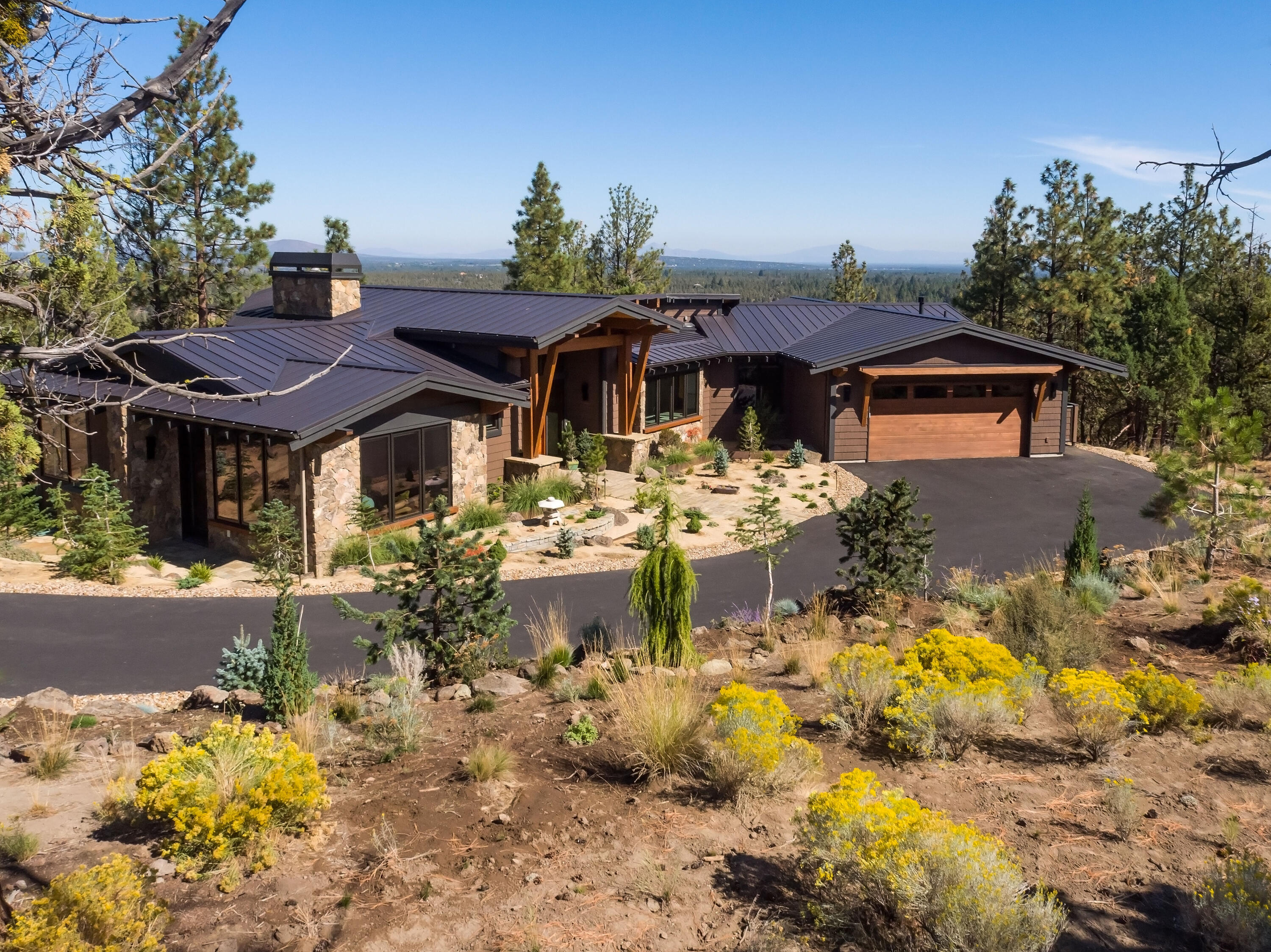 Stunning NW Contemporary home, recently completed by Norman Building & Design, is located in the gated North Rim community. Thoughtfully designed to bring the outside in, the single level home features vaulted ceilings & an abundance of windows. Mt Jefferson is framed by the great room windows; panoramic views include Smith Rocks & Powell Buttes. The high quality selections & attention to detail will delight you! Montana mossy custom fireplace, Humbarton lighting fixtures, white oak flooring, wood framed windows, extensive use of Sepele wood. The open, spacious kitchen features custom Anigre cabinets, Sandalus quartzite on the island counter, Ceasarstone, Wolf & Subzero appliances. Great separation between the primary suite & office, and the guest suites/den. Covered & uncovered decks with fire-pit & heaters. Oversized 2 car garage with dog wash, cabinets & more! Landscaped, treed, 1 acre corner lot is a peaceful retreat, while the location is close to trails, the river & downtown Bend