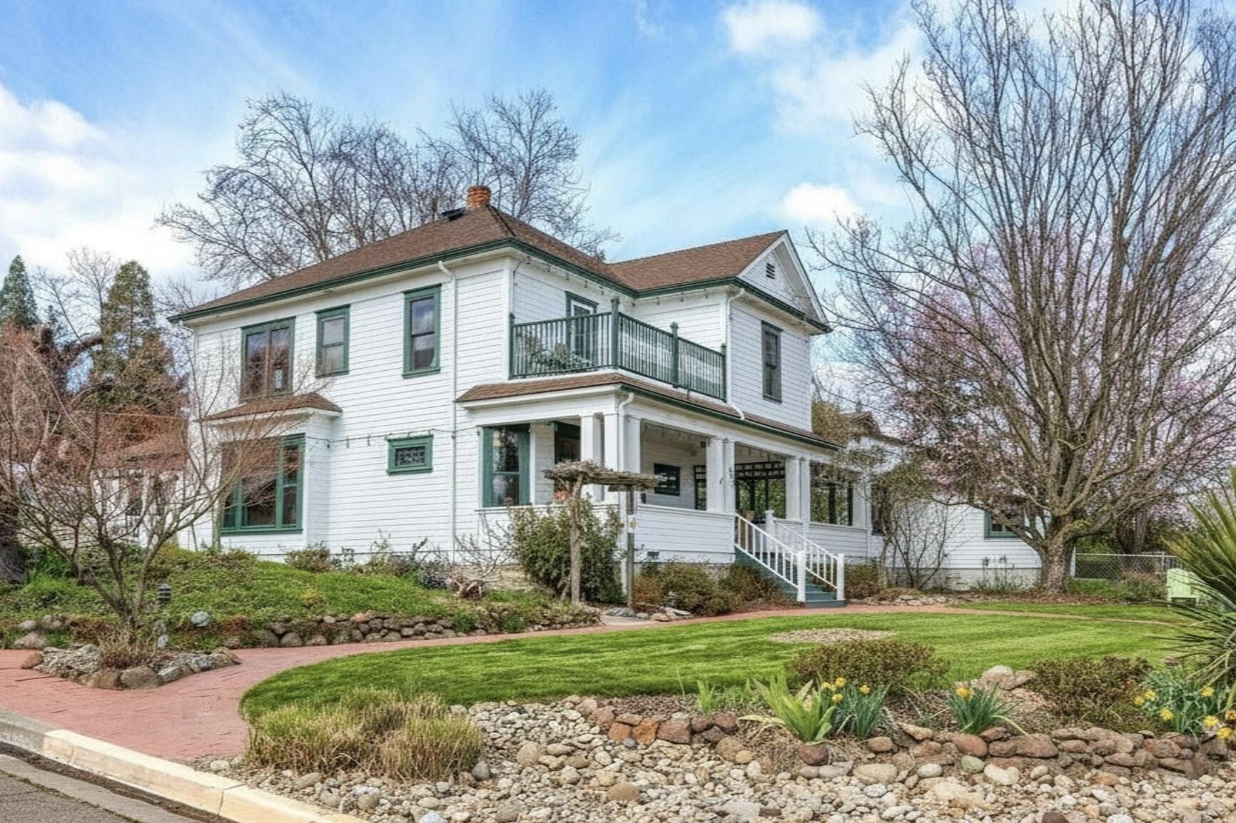 Just blocks from downtown, this historic gem blends charm and flexibility. Original fir floors, built-ins, high ceilings, and abundant natural light pair with modern updates. Enjoy the welcoming lawn, pollinator garden, and large covered front porch. The main level offers spacious living and dining areas, kitchen, half bath, and generous entry spaces. A 1-bedroom apartment with interior and private exterior access—includes a kitchen, laundry and full bathroom—a separate additional en-suite bedroom with exterior entry adds versatility. Upstairs are four lovely en-suite bedrooms, one with a balcony, all with updated Renewal by Andersen windows and balcony door. A detached 704 sq ft, 2 bedroom, 1.5 bath, single level cottage with its own address and electric meter provides added flexibility or income potential. With six paved off-street parking spaces, sheds, on-street parking, and alley access, this property offers exceptional possibilities for multi-generational living or investors.