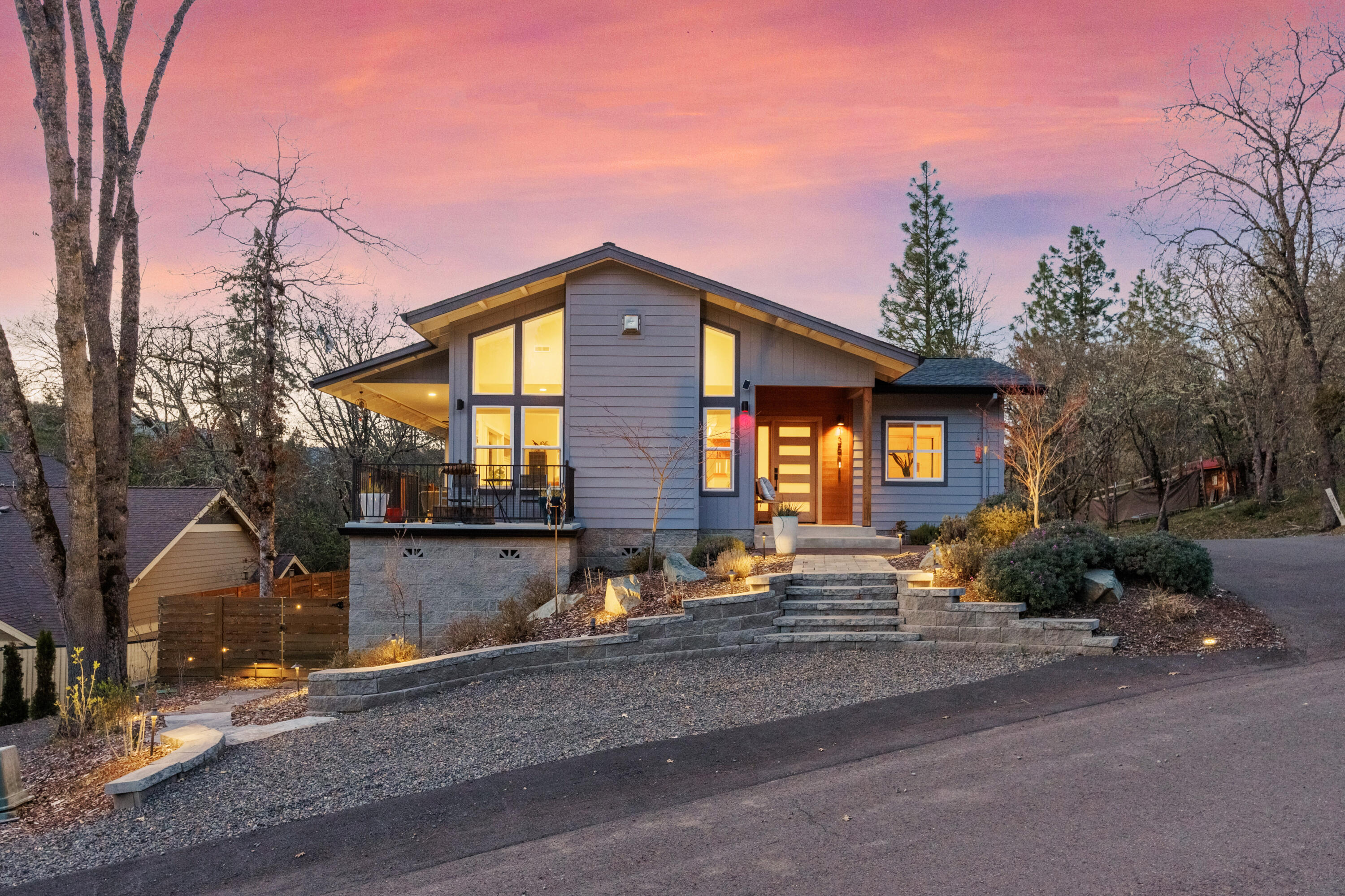 Gorgeous 2020 built contemporary home in a quiet Jacksonville location close to town & hiking trails. With strategically positioned windows & incredible natural light throughout the home, the open & inviting floorplan makes you feel right at home. The impressive great room w/hardwood flrs, gas fireplace & slider access to the expansive deck takes in the surrounding mountain views. The kitchen features a huge leathered granite island, stainless appliances & a pantry. Hard to find four bedrooms; including a main level primary suite w/ deck access & a spa bath w/ dual sinks, tiled shower & walk-in closet. The main level also features a 2nd bedrm/office, powder rm, & a laundry rm w/ abundant storage & sink. Two bedrooms, a full bath, & a den is downstairs. The backyard is fenced & has plenty of room for entertaining w/ several separate outdoor spaces. There is a two-car attached garage plus lower level detached workshop & a large shed in the backyard.