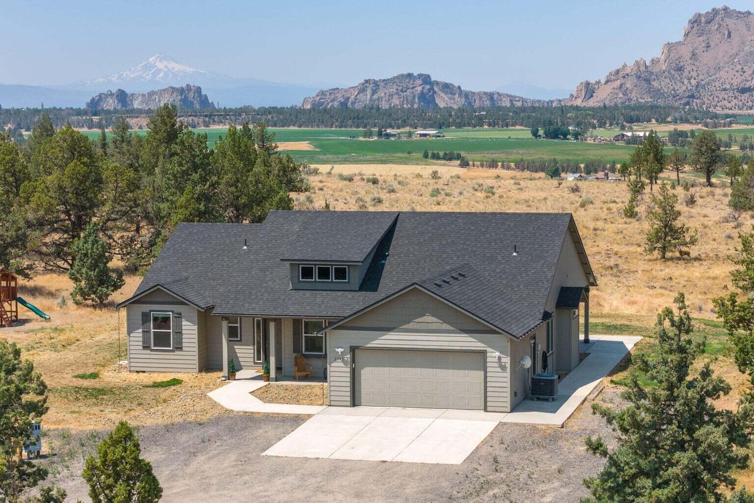 Embrace the opportunity to own a pristine 10-acre retreat just minutes from Redmond, where sweeping views and stunning sunsets await. Built in 2019, this 3 bed, 2.5 bath single-level home features an open floor plan, vaulted ceilings, a formal dining room, and a spacious primary suite. Spanning 2,047 square feet, the home is perfectly positioned to capture breathtaking views of Smith Rock, Cascade Mountains, Crooked River + the valley below. Each room offers mesmerizing views, and thoughtfully designed patios provide ample space for your dream outdoor kitchen + fire pit. The property also includes a newly-built 40'x80' shop with stained concrete floors, ready for plumbing + power, offering enough space for all your toys + an office. Easy access to public lands for horseback riding, biking, or ATV adventures! Embrace the tranquility + possibilities of this private retreat and make it your next home!