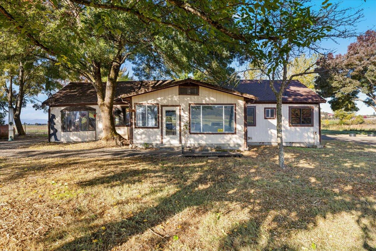 Welcome to your slice of country living in beautiful Eagle Point! This 8.75-acre property offers
irrigation rights, flat usable pasture, and stunning mountain views—all just minutes from town. The two bedroom, one and a half bath home is ready for your vision. Remodel the existing home or build your dream home in
this peaceful setting. Enjoy a gated driveway, barn, and shop, well and septic system already in
place. Whether you're looking for space for animals, gardening, or a quiet retreat with room to grow,
this property has endless potential. Property to be sold as-is, cash only, no owner carry.