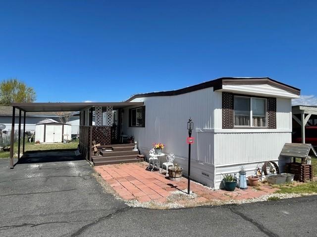 Well cared for older mobile home in a park. Featuring 2 bedrooms, 1.5 bathrooms, open floor plan with newer flooring throughout, vinyl windows, gas furnace and swamp cooler, plus a small fenced yard area off the back porch, metal roofing, and carport. Space rent is $340 per month and includes garbage starting May 1st. This home is move in ready! This is a 55+ Park.