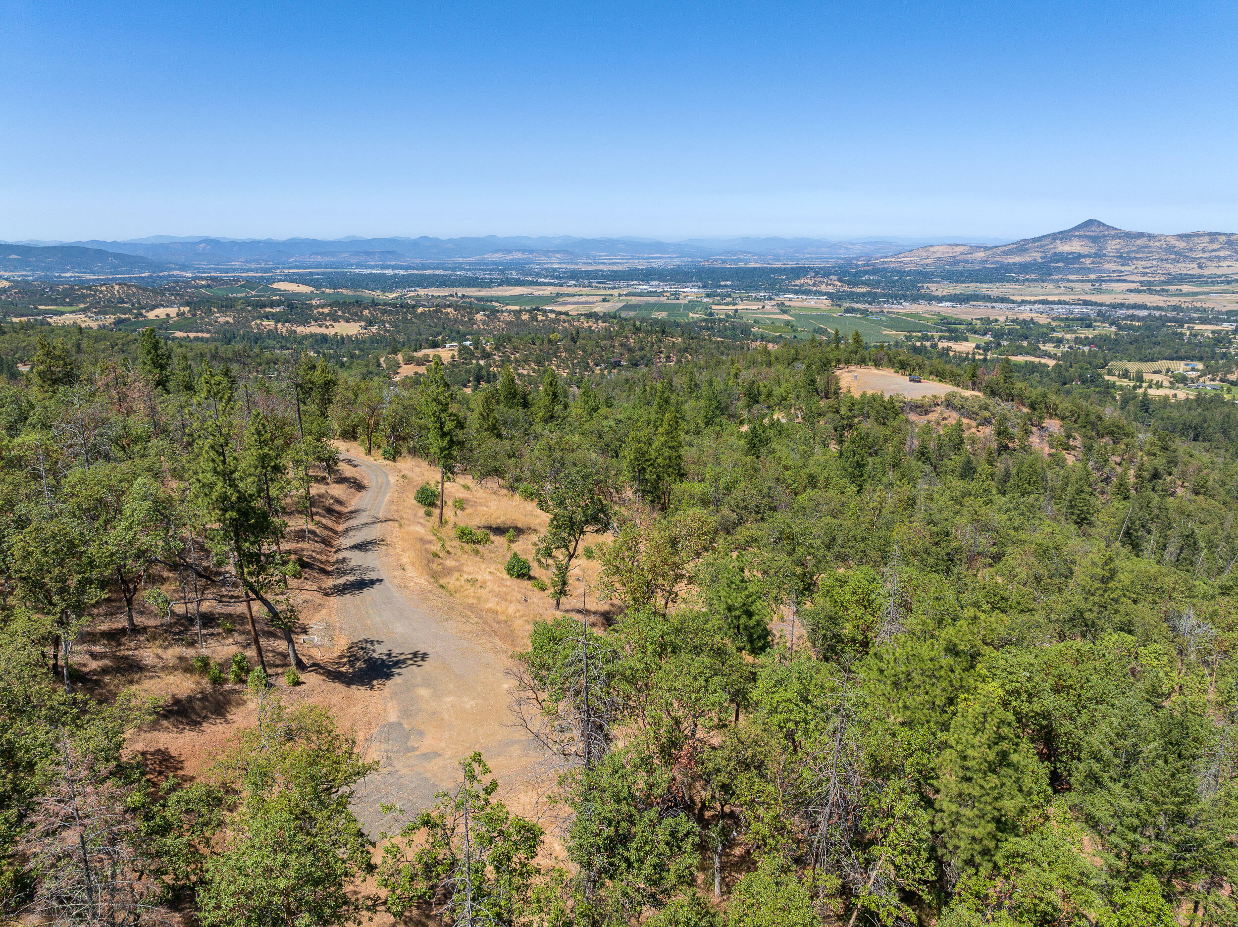 Coleman Hills View Parcels - a premier subdivision in gorgeous SW Medford.  This meticulously designed rural subdivision is the definition of private, rural luxury!  Two lots have sold and are in phases of construction, with utilities on site and septic approved this lot is prepped for building.  Measuring 60 acres, Lot 5 offers an expanse of forest to enjoy, including tall conifers and savannahs of oaks and madrones, the landscape and wildlife are diverse; Coleman Hills is a place any outdoorsman is sure to enjoy.  The homesite is carved in with utilities in place, it takes in North Easterly facing views of the eastern foothills of Medford and stares out to a centerpiece of Roxy Ann Peak.  A sloped meadow in front of the homesite provides for an ideal location for incorporating a deck balcony overlooking the entire valley while enjoying the serene forest just steps away.  Owner carry terms available.