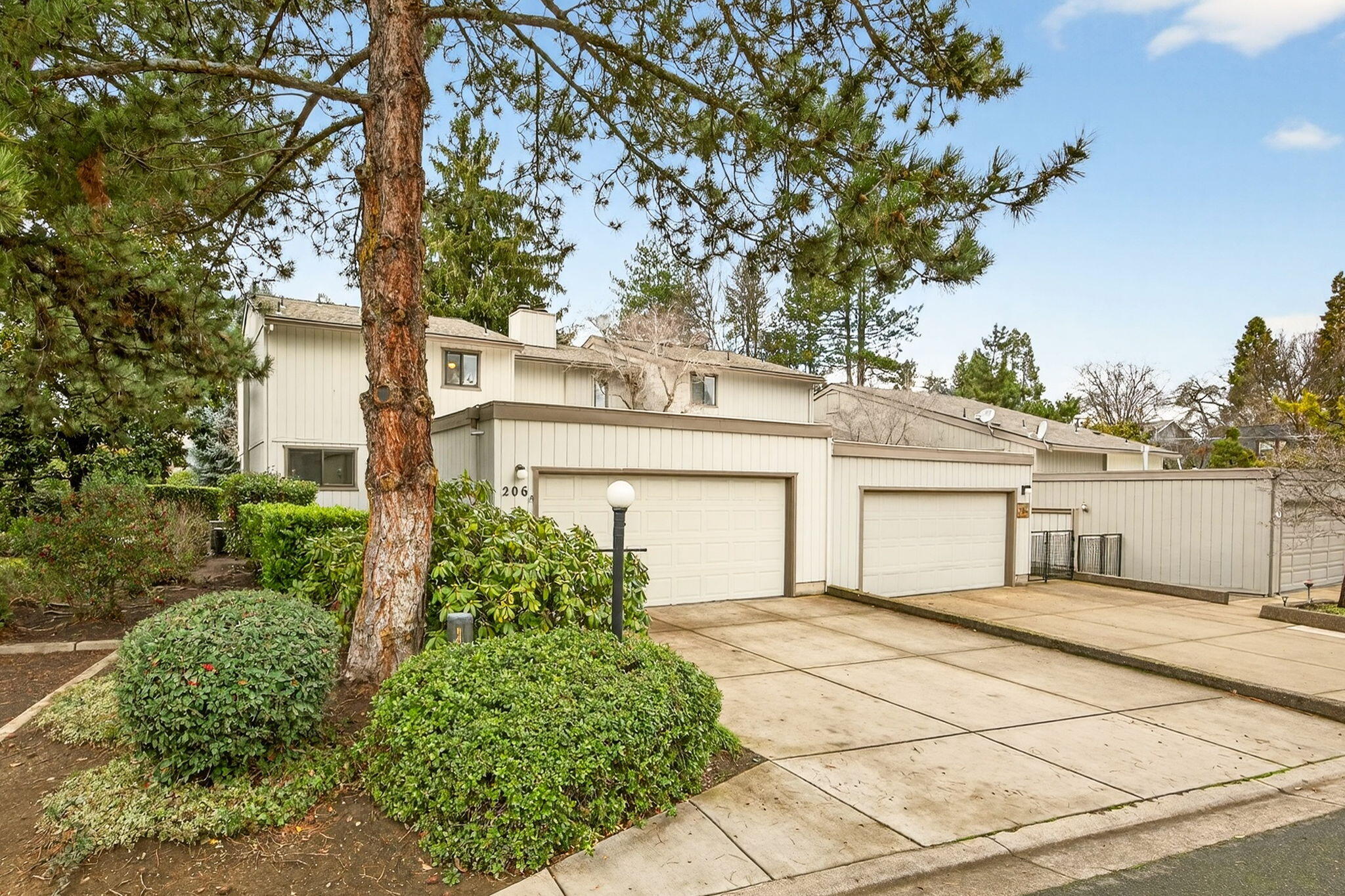 Beautiful, light-filled end-unit townhome in the quiet Medford Heights neighborhood. Large windows bring in abundant natural light and offer peaceful views of trees and open space. This 2-bedroom, 1.5-bath home has fresh interior paint and offers an excellent opportunity to add your own personal touches and upgrades. The main level features a cozy kitchen, open living and dining area, and an electric fireplace with a vintage stone surround. Upstairs are two generously sized bedrooms connected by a spacious Jack-and-Jill bathroom, along with a large laundry room. Ample storage is available throughout, including a walk-in closet and attached garage. Enjoy the west facing patio perfect for soaking up sunshine. Community amenities include a pool and shared outdoor space, with the HOA covering exterior maintenance. Conveniently located in desirable East Medford with close proximity to healthcare, shopping, and everyday conveniences.