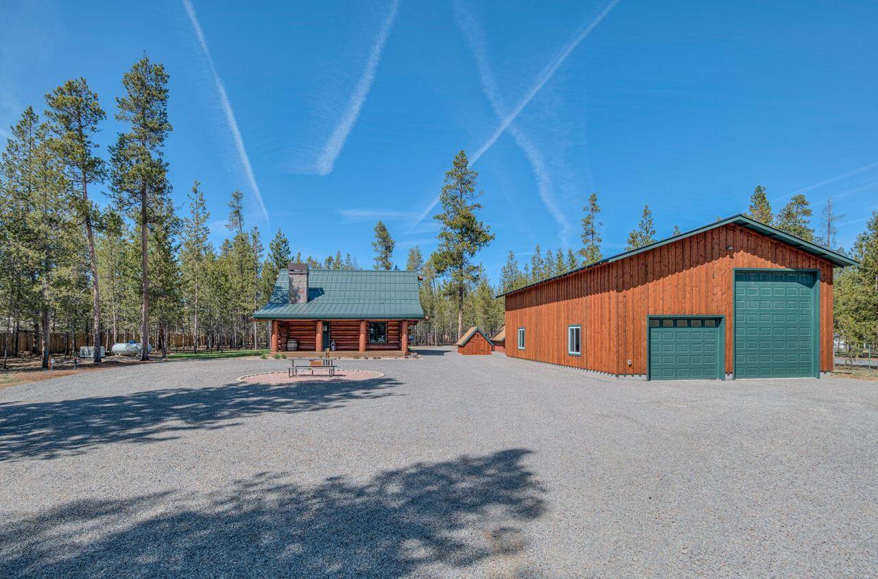 Exquisite custom-built Richardson Log home. Embraced by stunning 18 '' scribe log construction with impeccable craftsmanship and breathtaking design. Open floorplan with oversized windows bringing in the natural light, vaulted wood ceilings with floor to ceiling rock surround wood burning insert. The kitchen boasts solid knotty alder cabinets and quartz countertops. Downstairs bathroom has a tile walkin shower, Quartz counters, knotty alder custom cabinets and solid doors throughout. Upstairs is 16 x 22 spacious loft with lots of windows bringing in the outdoor light, alongside a walk-in closet and full bath with shower/tub. Outside, a 30X50 finished insulated shop provides ample space for RV 12X14 door or Sporting equipment 10X8 door. Situated on 1.71 acres, amenities include, sprinkler system, fire pit, storage sheds, and 1 RV hookups. Enjoy peace of mind with a backup generator and a fully fenced yard for enhanced privacy. Located 1 mile from LaPine State Park, Easy commute to Bend