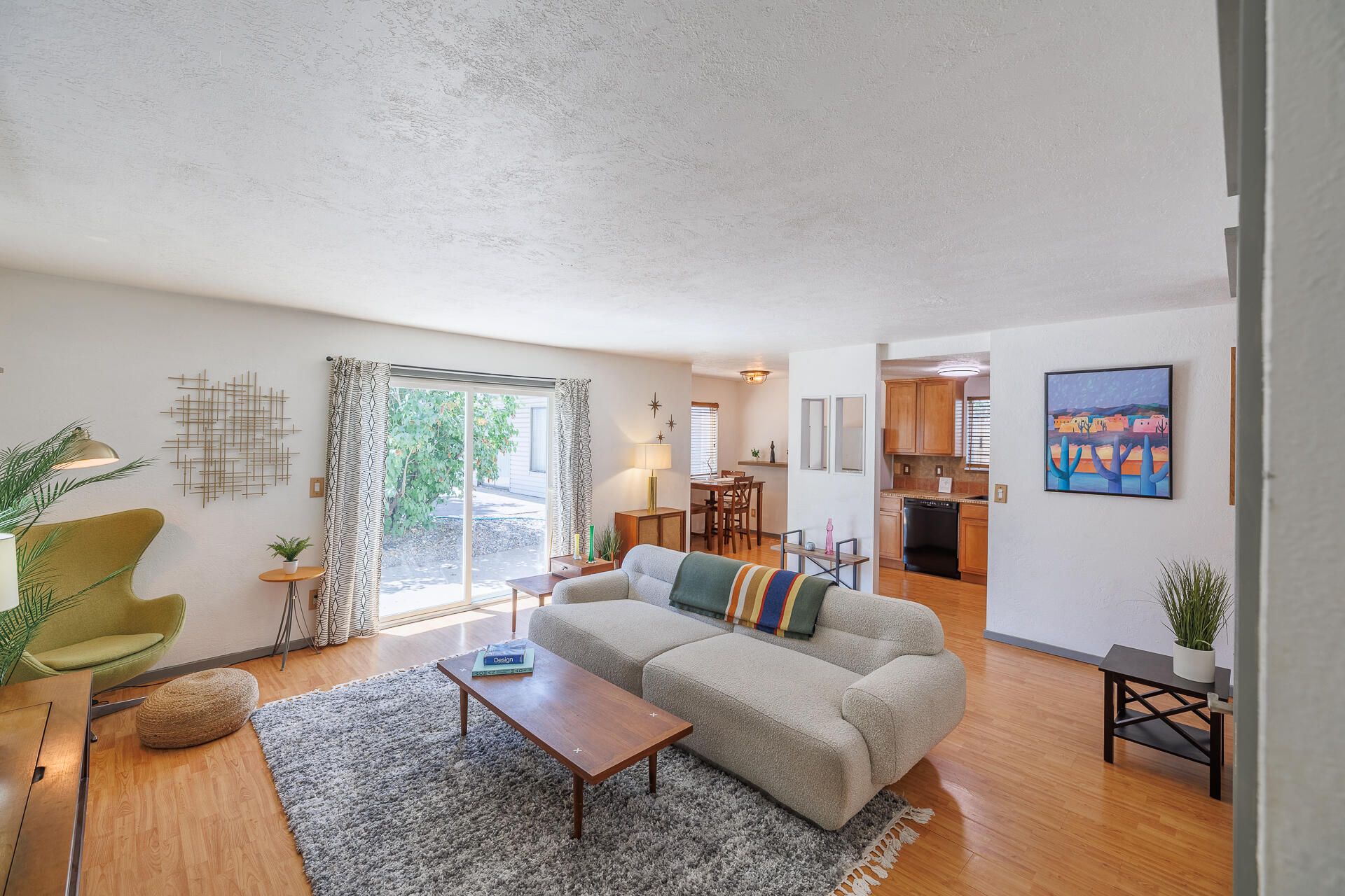 Welcome to this charming ground-level 2-bedroom, 1-bath condo offering low-maintenance living in the heart of Bend. With no stairs to navigate, this home is one of only two units featuring sliding doors that open to a courtyard, creating a bright and inviting living space. A separate one-car garage plus a designated exterior parking space provide excellent flexibility for vehicles, storage, or gear. The quiet location is close to nearby parks, scenic walking trails, shopping, dining, and medical facilities—everything Bend's east side has to offer. Inside, the home comes fully furnished with curated, vintage-quality pieces throughout. Everyday essentials are also included: in-unit washer/dryer, fridge, dishwasher, and portable AC. Whether a full-time residence or a flexible 30-day+ rental, this move-in-ready condo is an incredible find!