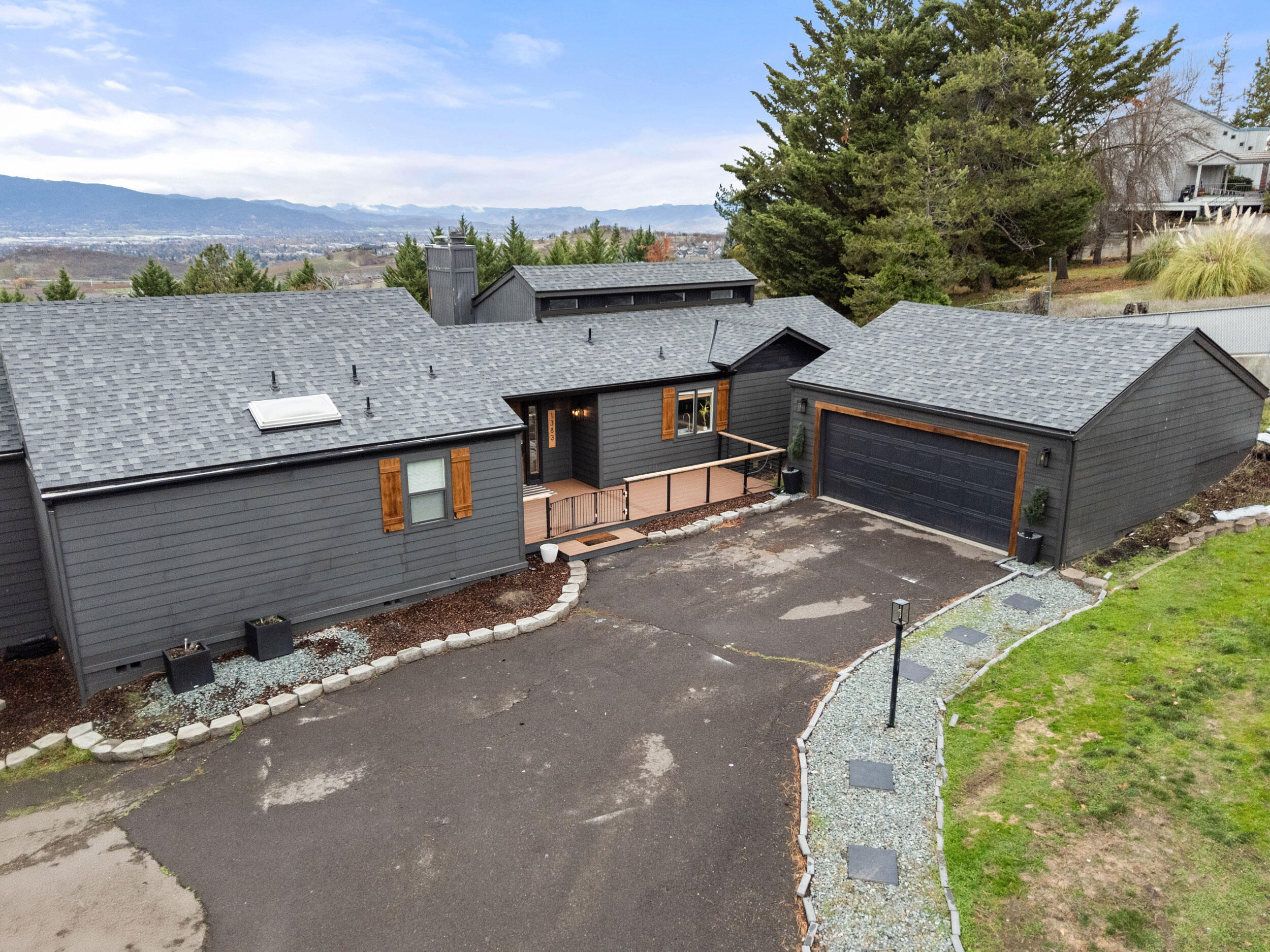 A beautifully updated East Medford home offering space, flexibility, and views! This 4-bedroom, 3-bathroom home has been thoughtfully refreshed from top to bottom. Enjoy multiple outdoor living spaces with three balconies offering beautiful views. Inside, the home features a fully updated interior with a tile backsplash, solid white oak flooring, luxurious carpet, a wood-burning fireplace, and tasteful finishes in a bright, open layout, with plenty of room for everyone to spread out. The lower level presents incredible multi-family potential with additional hookups already in place for a sink, making it easy to create a standalone living area or wet bar. Outside, you'll find plenty of room for parking (.36 acre lot), a detached garage (528 sq ft), and a NEW ROOF (2025) for peace of mind. If you're looking for an amazing home in a fantastic location close to everything, YOU FOUND IT!
