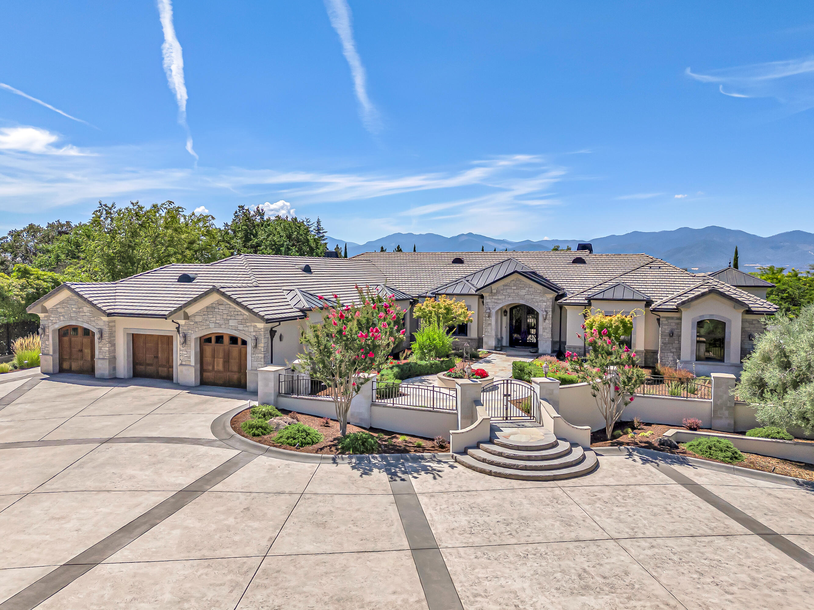 Enter across the threshold of this luxurious estate's grand custom iron and glass doors into a realm of refined class and sophistication. The entrance exemplifies the masterful design, boasting luminous windows with stunning valley views, gorgeous walnut flooring, one-of-a-kind ceiling art, and outstanding light fixtures that create a truly majestic ambiance of elegance and warmth with each room you enter. From the large spectacular gourmet kitchen with magnificent custom detail to the large lush outdoor living space perfect for entertaining, this gorgeous home is sure to captivate and impress the most discerning luxury buyer.