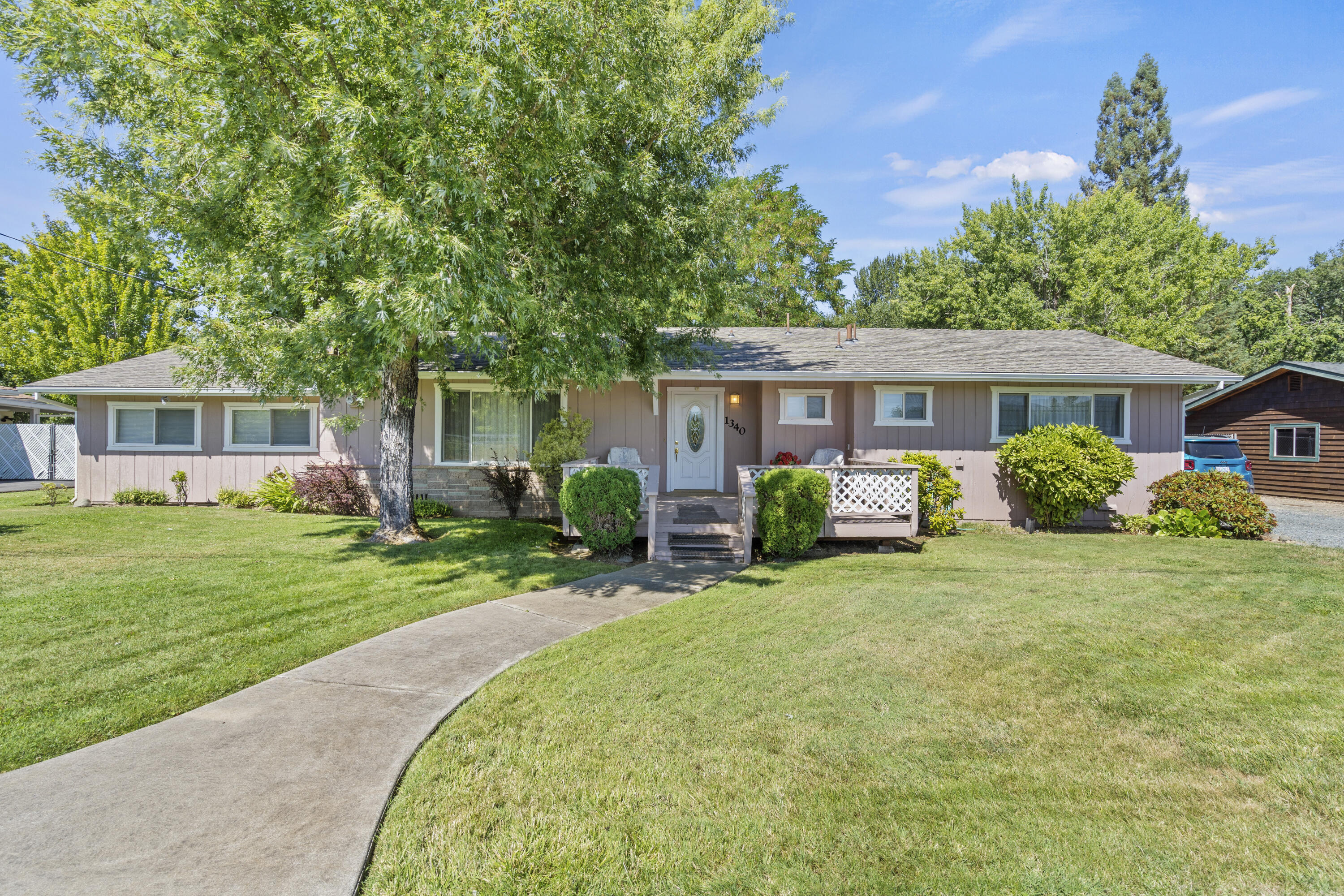 Welcome to 1340 Oija Ave, a charming residence on the outskirts of Grants Pass. Nestled on a well-manicured lot, the exterior exudes curb appeal with its tasteful landscaping, mature trees, and a welcoming front porch. As you step inside, you are greeted by an open and spacious living and kitchen area. The property boasts a large shop that has several divided areas. Inside the shop there is a living area with its own bathroom. Towards the rear of the property, there is a carport that can be used for RV storage. There are RV hookups on the property. To top it off the home sits on a spacious half acre parcel. This home wont last long, schedule your private showing today!