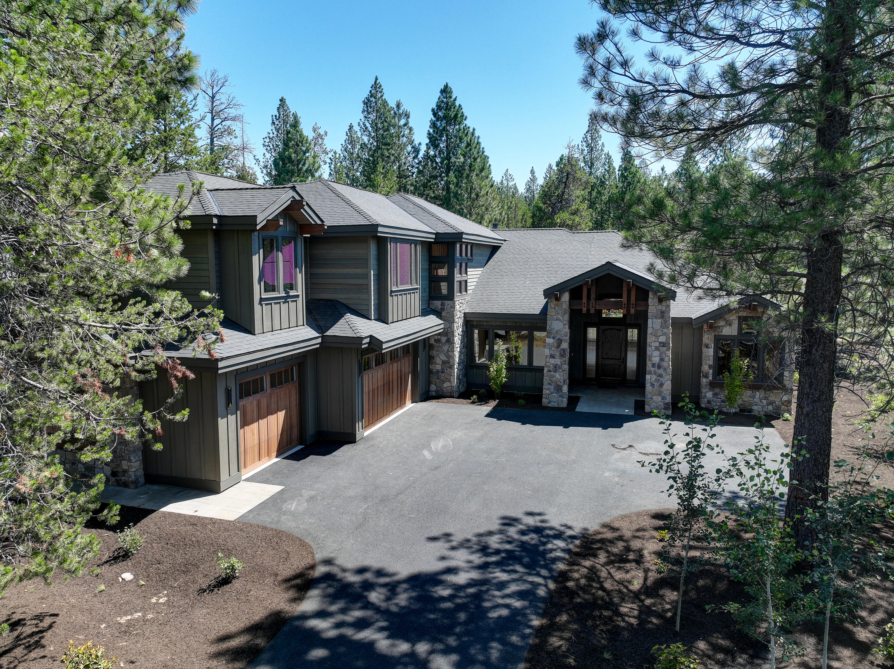 Brand new, gorgeous, move-in ready Caldera Springs mountain home. This home would make a terrific vacation rental or primary residence. Sale includes stunning Restorations Hardware furniture, bedding, and more. 4,341 sq. ft. of luxurious living space with extensive use of stone, quartz, granite, Restorations Hardware light fixtures, luxury appliances. Great room plan with fireplace, gourmet kitchen, walls of windows, high ceilings. Features include a main level primary suite with gas fireplace, 4 additional ensuites with private baths, main level den, 6th bedroom/bonus with bunk room that accommodates 6 bunkbeds. Space for all of your Central Oregon gear in the 3 car garage. Covered paver patio with gas fire pit backs to common area. Caldera Springs owner amenities include a 9-hole golf course, tennis, pickle ball, parks, paddle boarding, kayaks, pool, fitness, miles of walking & bike paths, lakes & water features.One mile to Sunriver and great proximity to rivers, mountains, and Bend