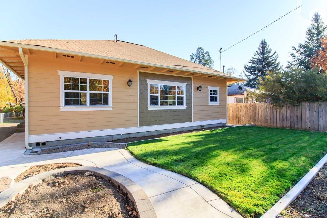 This wonderful Phoenix home has been completely remodeled all the way down to the studs. So much so that the assessor's office gave it an effective year of 2000. The floor plan is open and sunny. The kitchen features solid wood cabinets, new counters, flooring and stainless appliances. Nice size dining room opens to the kitchen and separated by a breakfast bar. Both bathrooms have been redone one with a tub/shower the other with a walk in cultured marble shower. Both with new flooring and vanities. The 2 bedrooms are nice size with 2 closest and each with ceiling fans. The laundry room is conveniently located off the kitchen with accesses to the patio and back yard. The detached single car garage would also make a nice workshop. This home is more than move in ready it's just about perfect. Ask for a complete list of improvements.