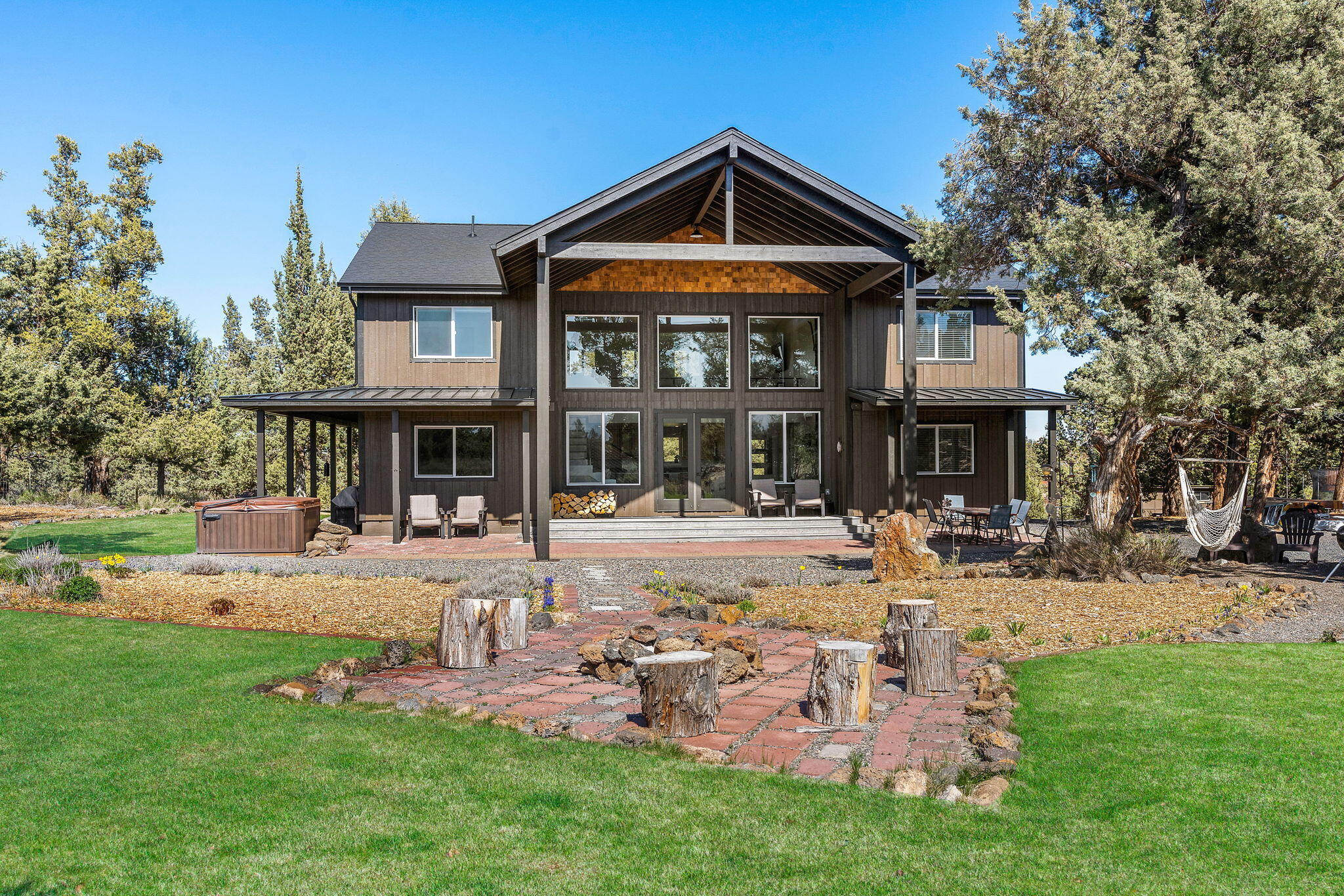 You ever dream of the perfect acreage oasis? Located between Bend and Sisters, in the Sister's school district, sits a completely rebuilt & remodeled (and I mean NEW) 2791SF home, very private with gorgeous Cascade Mountains views. Listen to the sounds of nature on the over 5 beautifully manicured acres that are fenced and cross fenced. The house is COMPLETELY remodeled with 4 bdrm, 3 full bath, office and mud room. Floor to second story windows overlooking the Cascades. Open floor plan with LVP floors, quartz counters, and built-in bar. New kitchen, new bathrooms, new everything! The property has three separate pastures, both irrigated and dry. It's truly a family's dream with a children's custom tree playhouse, shop, sheds, greenhouse, chicken coop, & a lined pond pool w/ a slide and cleaning system. The property is irrigated by a private well that is separate from the community water system. Only a couple minutes' walk to BLM trailheads & close to national forest trails.