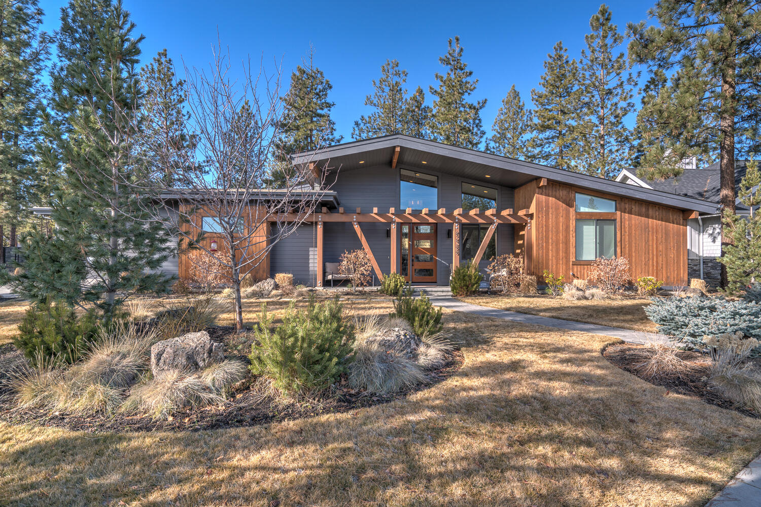 Welcome to a place you can truly call home in this single level Mountain Modern built by Rundle Construction, in beautiful Three Pines Ridge. Enjoy high vaulted ceilings and large windows in this open concept 3 bedroom 3 bath home with an office.  The gourmet kitchen with high end appliances, solid quartz countertops and modern finishes is perfect for entertaining while you chef it up. The home features built-ins throughout adding to the abundance of storage options as well as custom blinds, providing complete privacy or allowing the outdoors to shine through.  The second suite has its own bathroom and storage for when guests come to town.  Other features include a tankless water heater, exquisite butler pantry, mud room and oversized tub in guest bathroom.  Garage is a dream with a separate 3rd car garage for toys and tinkering, already equipped with 220v electric.  Preferred location gives you almost instant access to 650 acre Shevlin Park and just minutes to the heart of Bend.