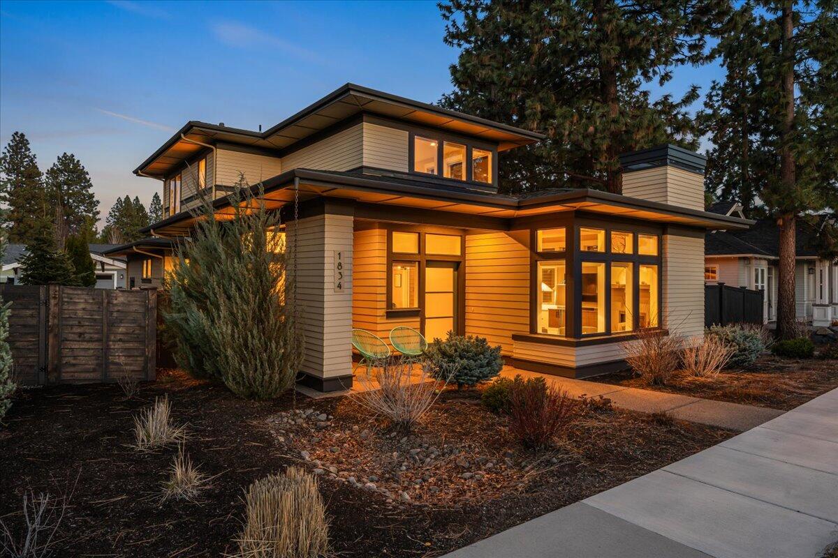 Live your best life in this Contemporary Prairie-style home nestled in the heart of Northwest Crossing!  Enjoy immediate access to Discovery Park, trails, schools, & the popular restaurants of the NWX Business District. An open floor plan fills with natural light & features wide-plank, oil-finished hardwood floors throughout the great room. A spacious kitchen with central island, professional series appliances, slab quartz countertops, walk-in pantry, & custom cabinetry anchors the main living space. The dining area opens to a covered patio w/custom fire pit, ideal for outdoor entertaining. The main-level primary suite includes a walk-in closet, tile floors, & a tiled walk-in shower. Upstairs are two additional bedrooms, a full bath, & a generous bonus room that doubles as a 4th bedroom, complete with peek-a-boo mountain views. Modern design, thoughtful finishes, and a premium location make this home a standout in one of Bend's most sought-after neighborhoods.