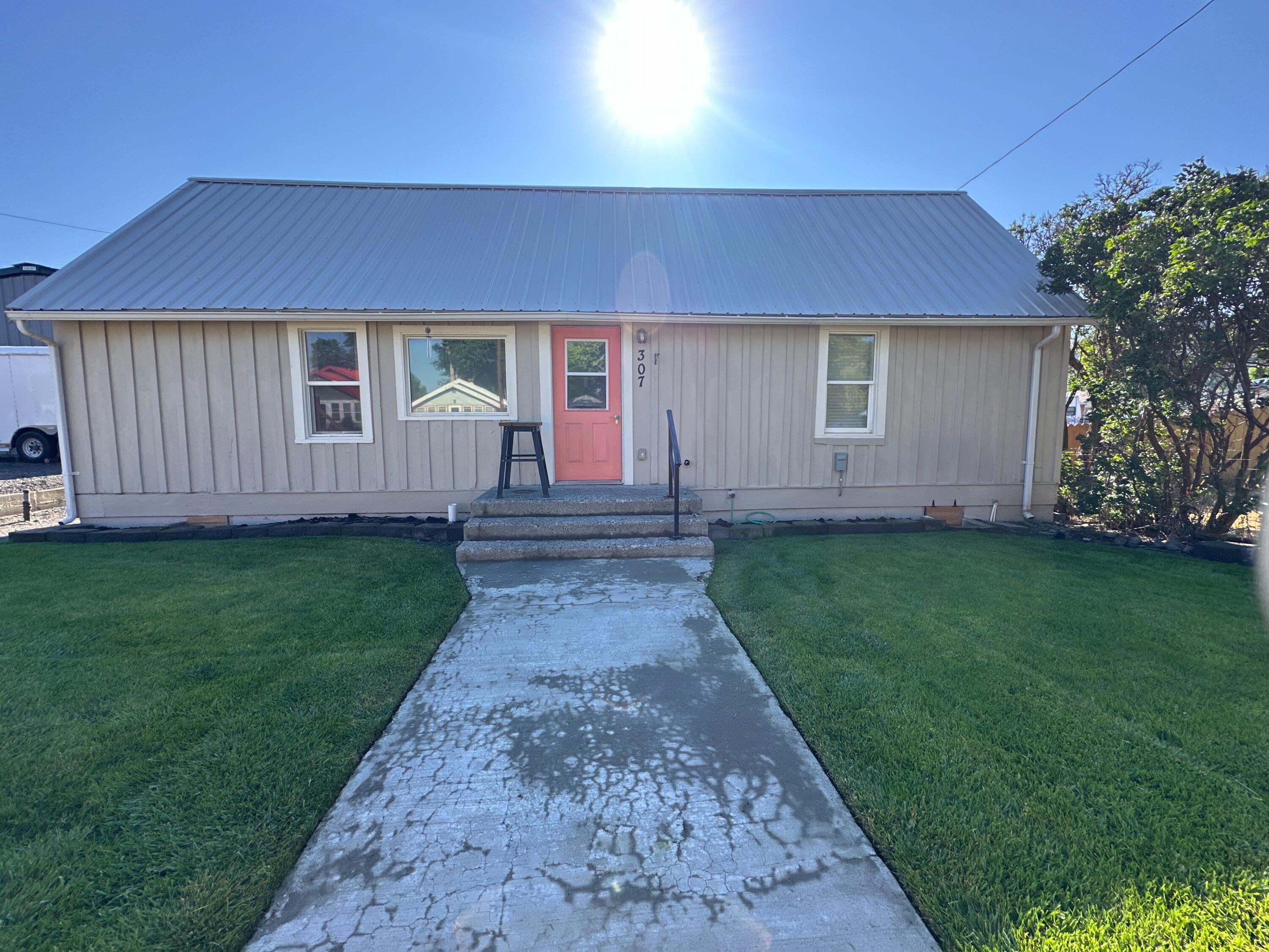 This charming three-bedroom, one-bathroom home encompasses 1,247 square feet of living space. Recently updated, it features a new metal roof installed within the last three years, exterior paint, new electrical wiring, and some upgraded PEX plumbing. The expansive kitchen offers ample room for a dining table, enhancing functionality. The interior showcases a blend of hardwood floors, carpeting, laminate, and tile.

Step outside to discover a beautifully maintained yard equipped with underground sprinklers. A hobby shop is conveniently located just a few steps from the back door, providing an excellent space for storage, a workout room, or pursuing various hobbies. Additionally, the property includes a designated garden area. The home is efficiently heated by a Toyo stove and cooled with a wall-mounted air conditioning unit. Located just minutes from downtown businesses, this property combines comfort and convenience.