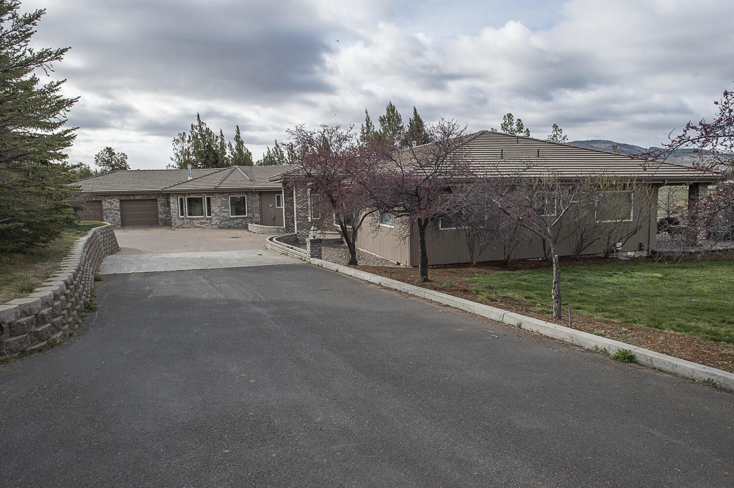 One of a kind, custom built, one story home with 13,200 SF of paved driveway. Perimeter fenced, some cross fencing and landscaping. Attached 946 SF garage. Some new carpeting.  Private location. Only 5-6 miles to Prineville, 12-14 miles to Redmond International Airport, a short drive to Bend or Mount Bachelor ski area. Paved Road.