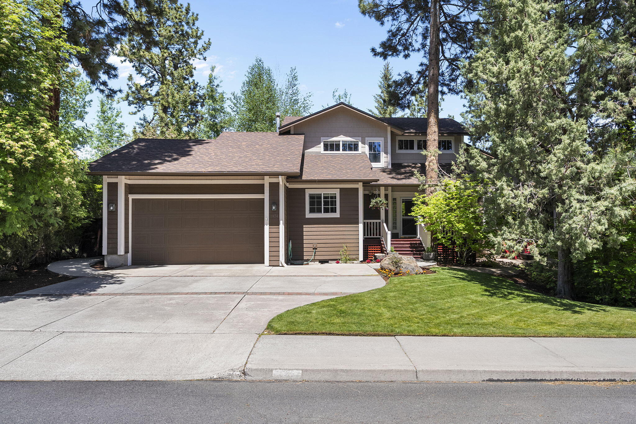 Stunning 4BR, 2.5-bath Craftsman home in NW Bend's coveted Newport Hills neighborhood. Main floor features a luxurious master suite with walk-in closet, large bathroom featuring separate shower/tub and double vanities, plus a dedicated office. Open-concept living spaces include a gourmet kitchen with granite countertops and stainless steel appliances, flowing seamlessly into the family room. Upstairs, three spacious bedrooms share a beautifully appointed bathroom. Vaulted ceilings, an expansive double garage, and massive laundry/mud room provide exceptional functionality. The meticulously landscaped yard is a true outdoor oasis, surrounded by majestic Ponderosa pines, with a covered front porch, expansive back patio, and charming gazebo. Perfectly situated within walking distance to High Lakes, Pacific Crest, and Summit schools, this home offers the ideal blend of comfort, style, and location in one of Bend's most desirable neighborhoods.