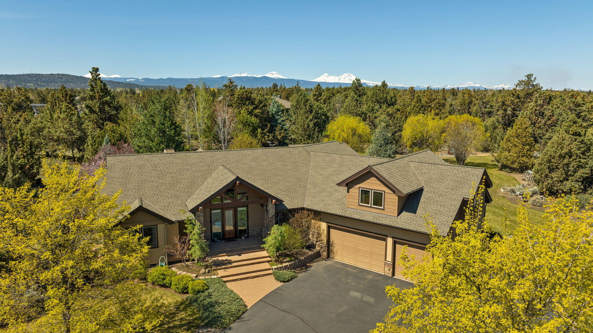 Show stopper! Stunning NW Lodge-style home offers the perfect blend of luxury, privacy, and convenience, in desirable Overtree Ranch on beautiful 2.5 acre lot!

Great 5-Bedroom design, ideal for families who enjoy peaceful living w/out sacrificing proximity to top-rated schools, parks, & amenities of Bend.

Exterior landscape offers in-ground swimming pool w/ poolhouse (1/2 bath & outdoor shower). Custom-built stone fireplace creates the ultimate gathering spot for cozy stary evenings. Discover the tranquil pond w/ running creek & picturesque footbridge, adding to home's serenity.

Custom chef's kitchen is the heart of the home, featuring high-end appliances, ample storage, & top-quality finishes, ideal for cooking & entertaining alike. Main level offers 2 luxurious primary suites, w/ direct access to the grounds-perfect for multigenerational & hosting. Vaulted ceilings w/ exposed timber beams enhance the lodge-style aesthetic. This property is more than a home-it's a lifestyle.