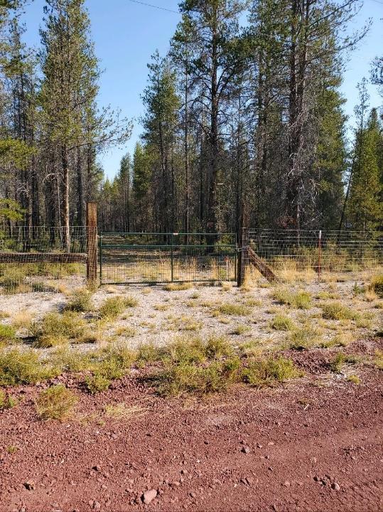This level parcel in Mt Scott Meadows is covered with pine trees, has an excellent well with pump and perimeter fencing with two gates.  Corner lot is located in area of well-kept parcels.  The cinder roads are in good condition and power is available at the road.  Please call with any questions and a tour of the land.