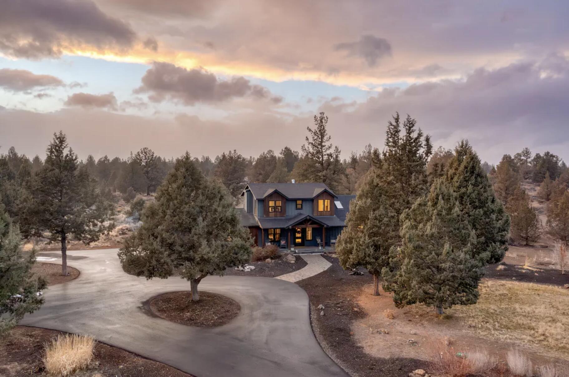 This renovated NW modern farmhouse on 9+ acres offers luxury living w/ strong investment appeal, generating $89,412 in 2025 bookings & attracting year round demand. Minutes from Bend & Tumalo, the home includes a bright great room w/ wide plank floors, exposed beams & expansive windows that frame the surrounding acreage. The chef's kitchen features white oak cabinetry, quartzite counters & high-end appliances designed for elevated everyday living. The main level primary suite provides a quiet retreat. Upstairs are 2 well-appointed guest bedrooms with stylish finishes & peek-a-boo Cascade views. The guest spaces adds 2 private ensuite bedrooms & valuable flexibility for larger groups or multi generational living within a single rental. Outdoor amenities include a heated RV garage, sauna, cool shower, 9 hole disc golf course, greenhouse & lavender fields. With proven revenue & resort-like amenities, this property stands out as a premier income-producing retreat.