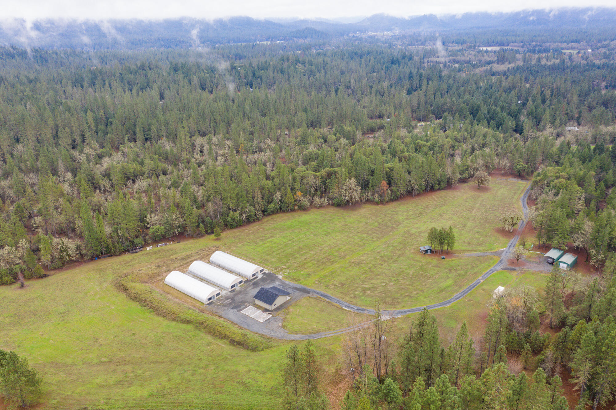 Bring your OLCC Producer License!  Privacy and peace behind two security gates down a secluded road with 40.63 acres of EFU land and Homesite Approval. Three 30' X 96' greenhouses with propane heat used for all year growing.  These highly efficient greenhouses feature power operated interior light dep curtains, concrete perimeter foundation, water tanks, and 1000 watt grow lights.  The property includes a 32 X 32 insulated dry building, large covered RV space with 35' camper with water and septic.  The 9'6'' high cube shipping container for storage as well as the additional green dry building located by the camper are included.  Water rights will be approved on or about 01/14/2022 for 35 acres.  Documentation is available regarding the approval.  Bring your plans and builder to start your custom dream home with panoramic views!  Rocked roads ready.  Owner financing  is available!