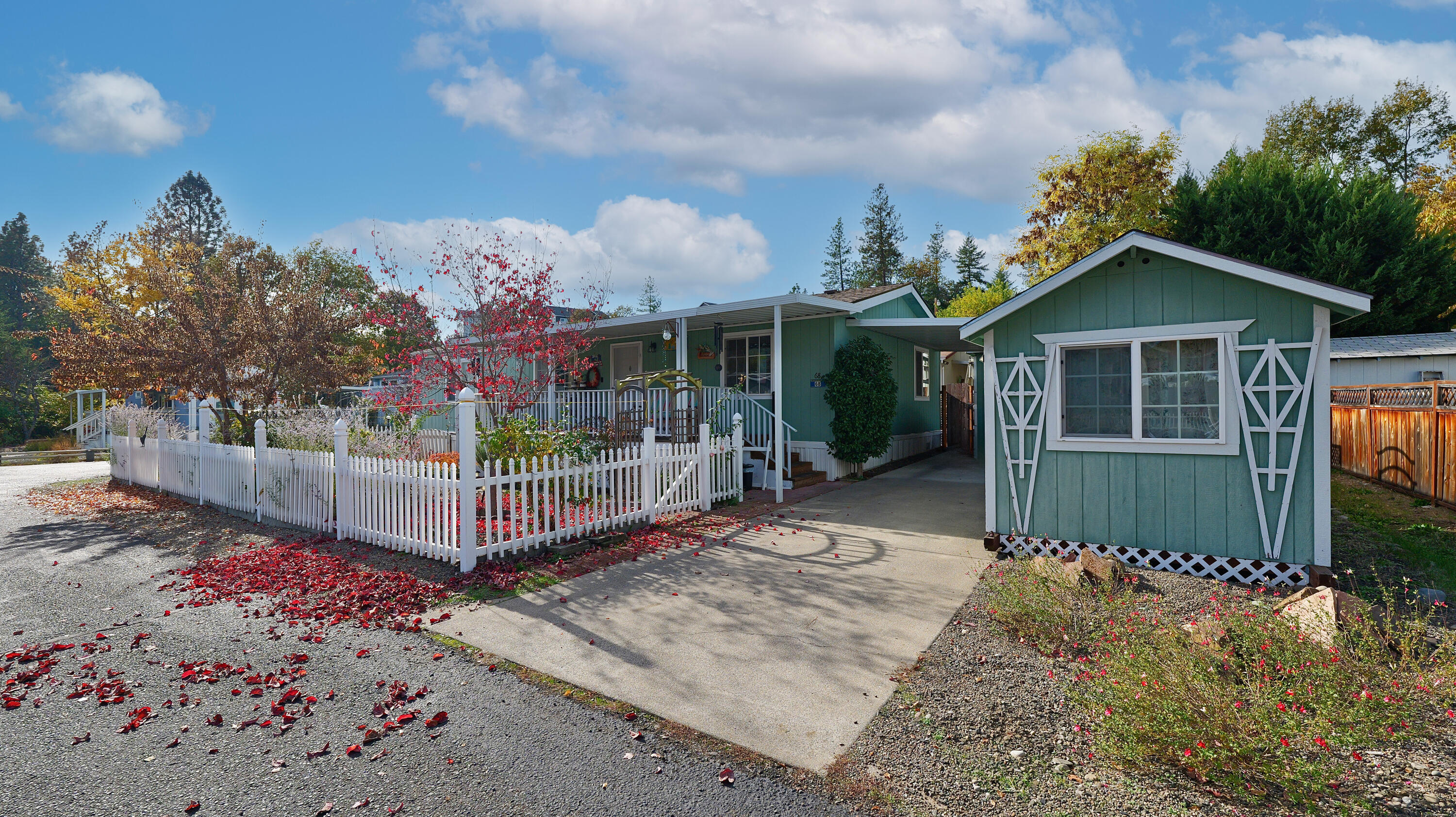 Beautifully maintained 3-bedroom, 2-bath home in one of Shady Cove's most desirable 55+ communities! This spacious double-wide features an open, light-filled floor plan and sits on a prime corner lot offering abundant parking. Enjoy relaxing on the covered front and back decks or tending to the nicely landscaped yard with garden area. Recent upgrades include a new roof, new heat pump, and a dual-fuel generator system with 100 gallons of propane—perfect for peace of mind during outages. The split floor plan offers privacy, with a comfortable primary suite featuring a walk-in closet and private bath. Two large storage sheds (8x10 & 8x16) provide plenty of room for tools, hobbies, or seasonal décor. The fenced backyard is ideal for pets or quiet outdoor enjoyment. Just a short distance to restaurants, the post office, library, grocery store, and Shady Cove's own famous Phil's Frosty. A rare combination of comfort, convenience, and community!