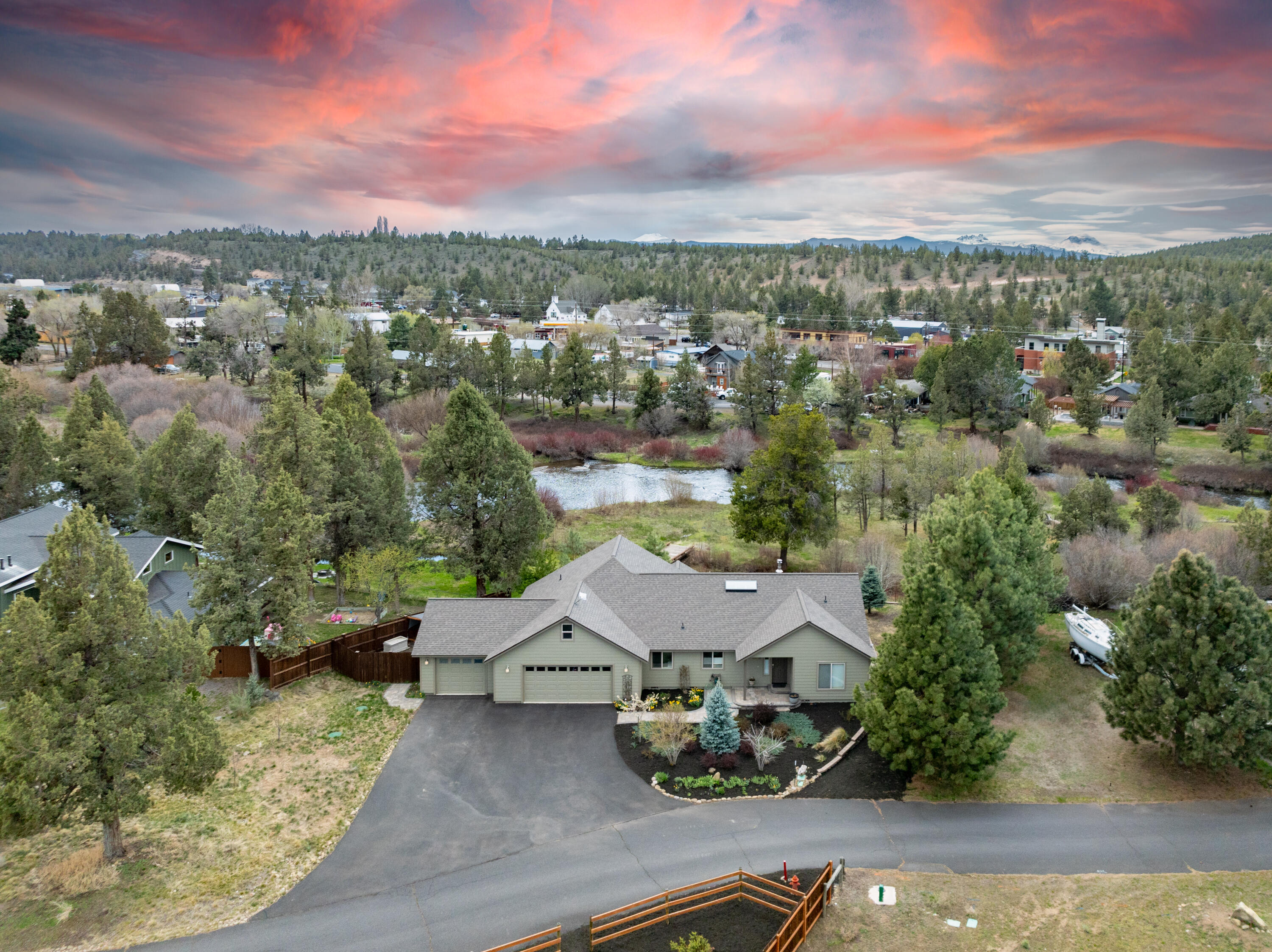 Choose to fish, float, or just simply sip coffee along your own slice of the Deschutes River! This stretch of the river is uniquely special due to a small riffle that creates an
audible water sound 24 hours a day. The home features vaulted ceilings in the open great room as well as the primary suite, which is separated from the other two bedrooms. There is a three car garage & a large driveway with plenty of parking. On the other side of the lot there is a large greenhouse, fenced garden area with raised beds & irrigation. There is also a large shed with power & room to build a barn/shop, room for horses or a small hobby farm. Plenty of parking for all your toys! Just minutes from the new Costco! Many eating & drinking options are only a ten minute walk from this rare south facing riverfront home. Plenty of trails are also nearby. Property is being offered fully furnished & is an active vacation rental. You must see this stunning property in person! Home is NOT in the flood plain.