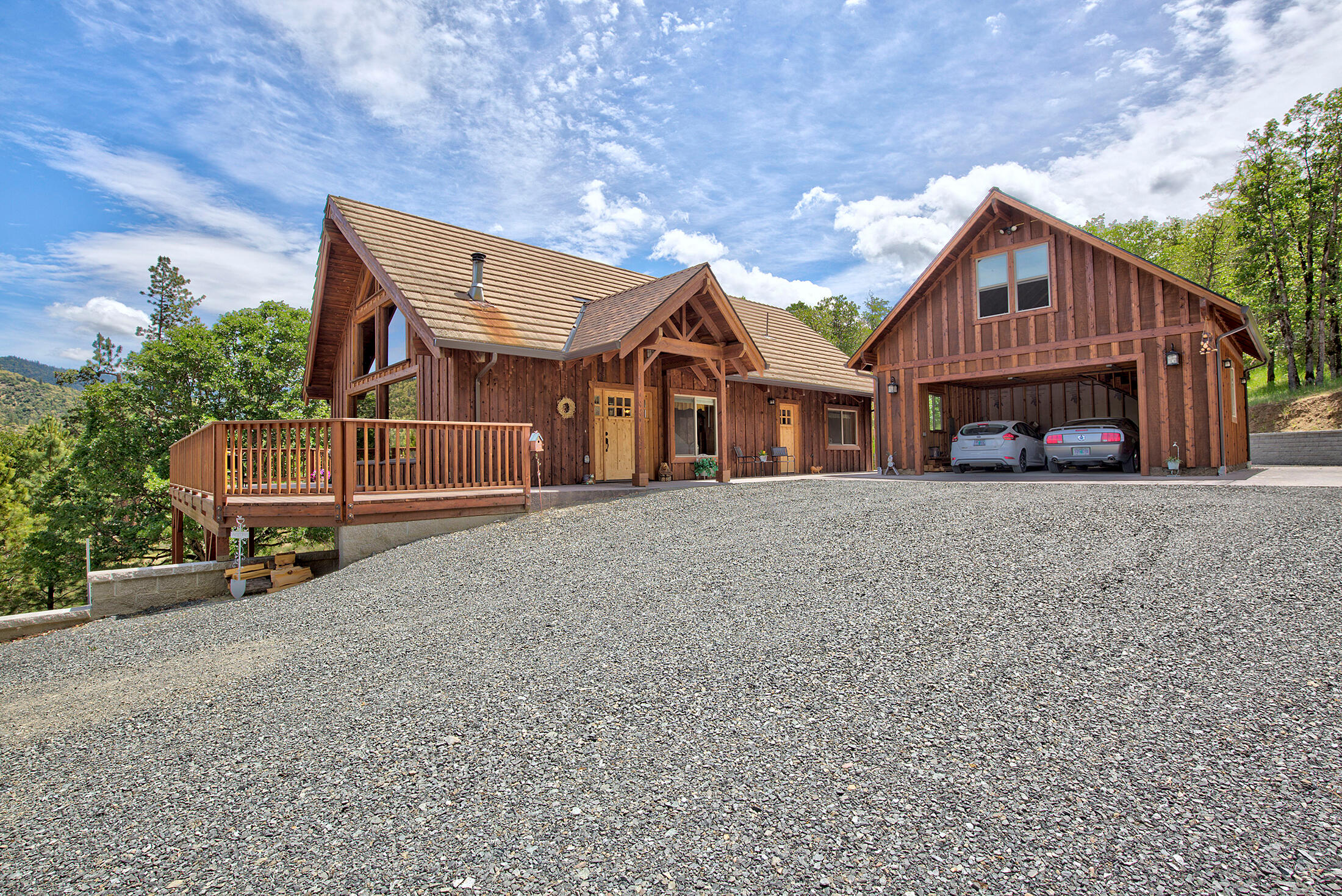 Wow, This gorgeous custom crafted home has views, views views! You will love the well thought out open floor plan, loft with a view & cathedral ceilings! Enjoy 3 bedrooms 2 baths above grade AND a separate living area with another bed and bath in the walk out Basement of aprox. 390 sq. ft. NOT counted in the square footage! You will delight in your large separate shop of 576 square feet and the extra! 528 Square Feet of Attic space above the shop, could this be your Guest House? With the shop and attached garage you have a total of 4 garage spaces. Hard to Find Large Acreage backed to BLM, approx. 15 minutes to shopping! You will see quality workmanship through out this entire property. Beautiful scenic wooded acreage & approx. 3 flat acres. You'll find extensive landscaping brick work and stamped concrete through out. This amazing property is a combo of an open space meadow and beautiful mature trees. Newer, windows, doors, heat pump and condenser.