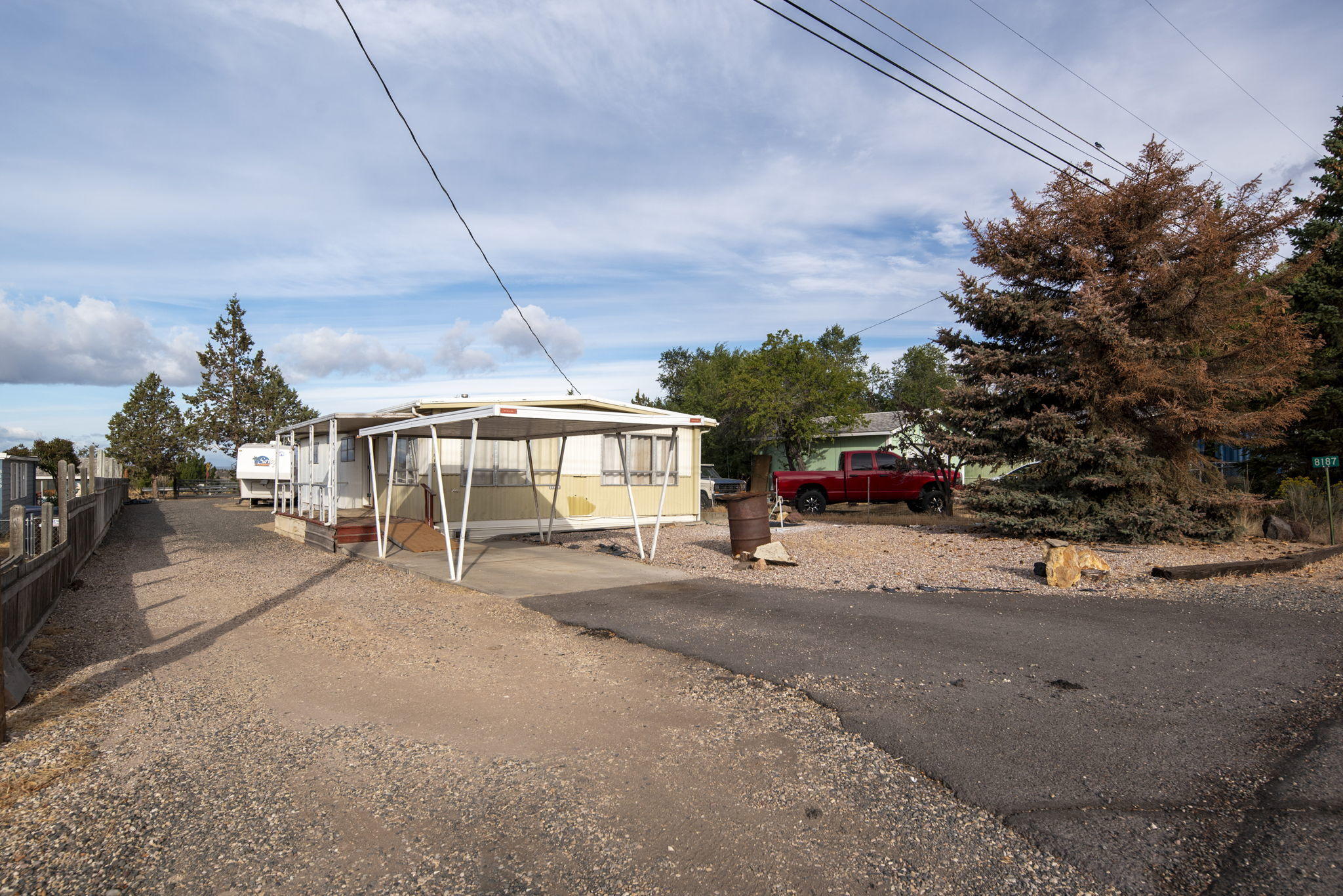 Affordable with a view! Enjoy stellar Cascade Mtn sunsets & the sunrise over Smith Rock. This home was just refinished on the inside w/all new kitchen, paint & flooring throughout. Open living area w/central pellet stove to keep you cozy this winter. Covered front & back decks. RV parking, storage buildings & access from front & back of the lot. OWC possible with $100k down payment.  Cash only due to age of home.