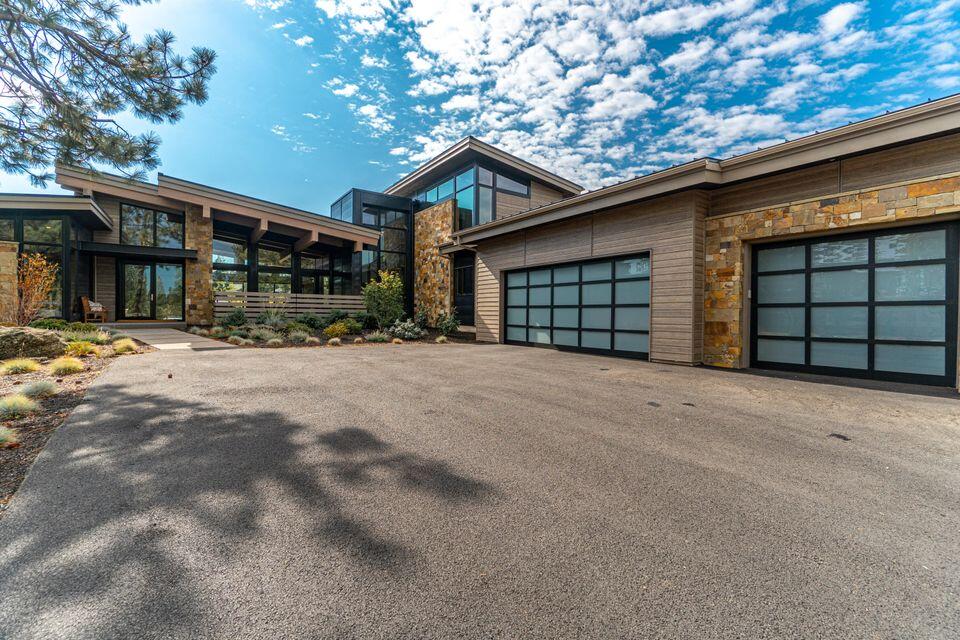 Stunning Tetherow Mountain-Modern residence inspired by Martis Camp architecture in Lake Tahoe. Designed by DesignHaus and built by Bend Trend Homes, attention to detail and quality exudes throughout. The expansive great room with unique 3 dimensional crossing beams immediately captures the essence of this distinctive property. Large metal-clad 3-panel sliding door system allows for a flowing indoor-outdoor living experience. Open kitchen & great room concept with large Statuario Milane quartz island surface. Wolf Range, dual dishwashers, built-in Wolf coffee/espresso machine, steam oven & microwave and Sub-Zero Fridge showcase the quality of appliances. This special property has it all...4 Bedrooms; 4 ½ Baths, Office, dining area with built-ins; 2 Bonus/
media rooms, front and rear outdoor patios, large 3-car garage with epoxy floor all situated on an almost ½ acre lot. Elegant master bathroom with soaking tub, large walk-in shower, and radiant heated floor.