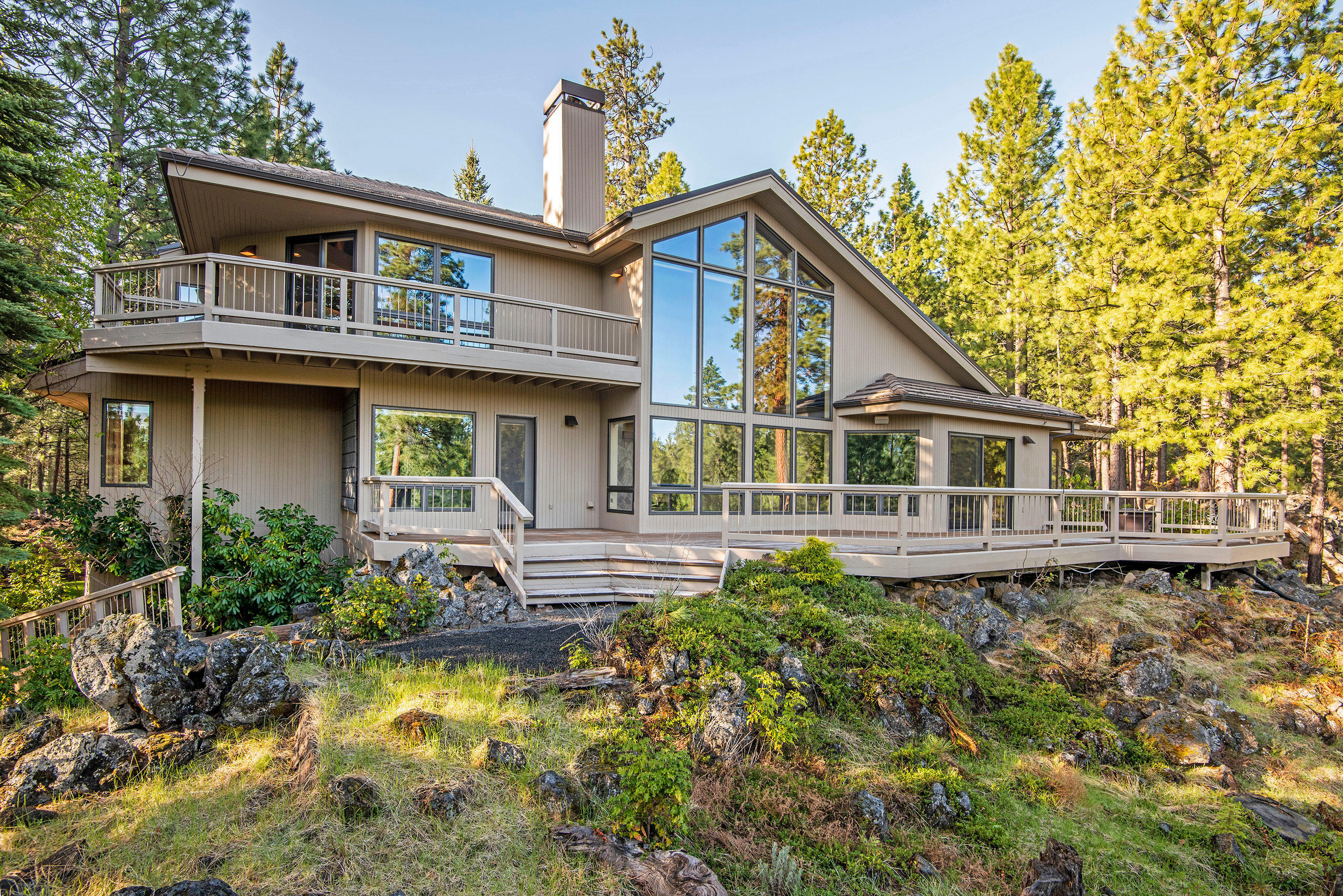 The ultimate entertainers home! Located on a peaceful private lot, fully landscaped with mountain views! Main level offers a custom kitchen with tons of storage and room for entertaining. Enjoy the views from the large deck just off the kitchen. Great room has a gorgeous wood-burning fireplace perfect for those cozy winter days. Jack and Jill on-suites on main level. Laundry room off of garage entrance. Office is a great flex space and can be used as an additional bedroom conveniently with full bath just across the hall. Master on upper level is very private with a cozy sitting area just before you enter and a private deck. Over-sized 2nd Master on upper level has it's own exterior entrance. Move right in and enjoy all that BBR has to offer! It's a great place to vacation, and an even better place to live!