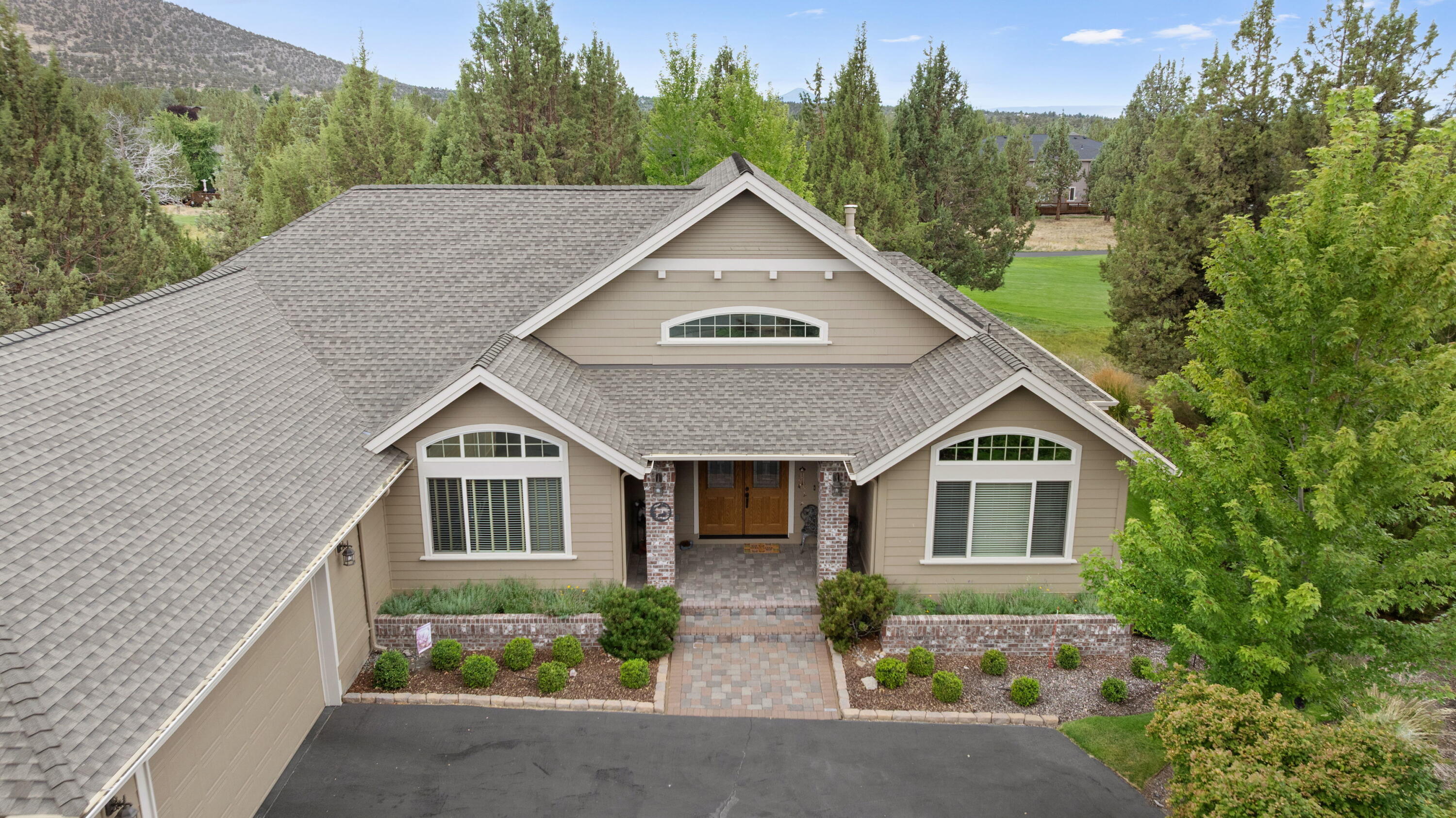 Discover the ultimate Central Oregon lifestyle at 909 Willet Ln. This custom home blends comfort, elegance, and indoor-outdoor living, perfect for both relaxation and entertaining. A vaulted, light-filled great room with gas fireplace, reclaimed wood beam flooring, and built-in bookshelves invites you to unwind or gather with friends. Work from home in the office/den with custom built-ins, then retreat to the private primary suite with double-sided fireplace, spa bathtub with jets, and French doors to a serene patio.
The kitchen has granite tile counters and matching inlaid flooring, ideal for hosting or quiet mornings. Outside, the 2 patios,  and a tranquil water feature create an oasis for dining and sunset cocktails. Overlooking the 2nd tee box, you'll enjoy golf course views, a vibrant community atmosphere, and an oversized 1,107 sq. ft. garage for vehicles and hobbies. Whether a vacation escape, STR, or forever home, this property has it all.