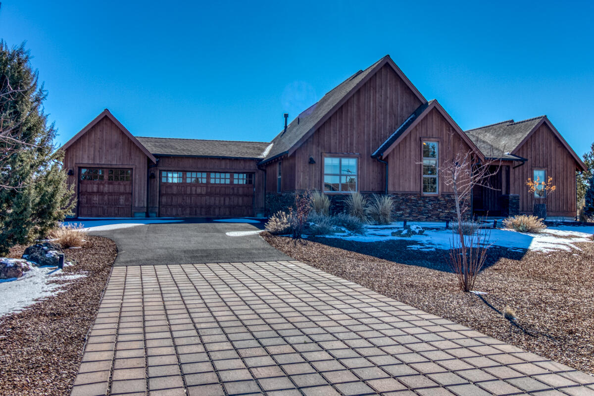 Escape to your retreat in this single story ranch style home positioned on a quiet cul-de-sac at Brasada Ranch. Thoughtfully landscaped with native plants, the exterior features-stained wood siding, and extensive stone accents. The open floor plan lends itself to an abundance of natural light and creates a feeling of spaciousness as you step inside. Featuring beautifully crafted built-ins throughout, hardwood floors, and a stone fireplace in the Great Room. This home is perfect for entertaining, with stainless steel appliances, a walk-in pantry, and a large granite island. A calming view of the surrounding high desert landscape can be enjoyed from the outdoor living space that abuts to over 20,000 acres of BLM land.    
The primary suite features a large walk-in closet, double sinks, a soaking tub, and a floor-to-ceiling tile shower. Two additional bedrooms with a full bathroom, laundry room, and a large three bay garage complete this home.