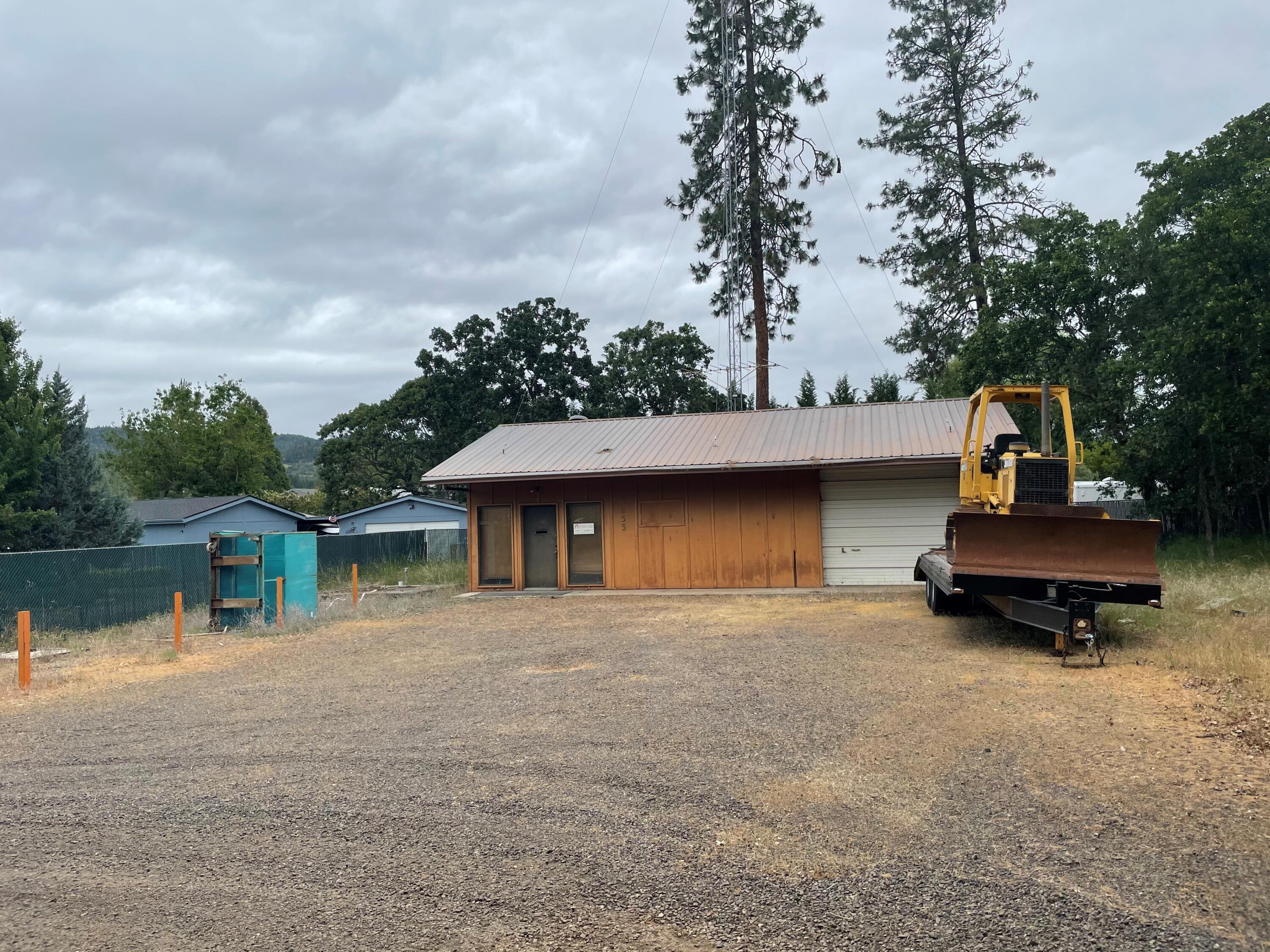 What a great opportunity here for your investors...or for anyone that wants to own a shop with tons and tons of parking for equipment or RV's and the potential to build a house or add a manufactured home (buyers: please check with county and do your own due diligence) within a very short distance to downtown Shady Cove, Lost Creek Lake, schools, parks, and the fabulous Rogue River.  This is very close to where the rafters go in and out on the Rogue River. There is so much potential with this huge lot. You can access the lot from two locations off Rogue River Dr (makes it easy to go in and out) and the entire property is nearly completely fenced. Possible owner financing available. Do not miss this great opportunity!