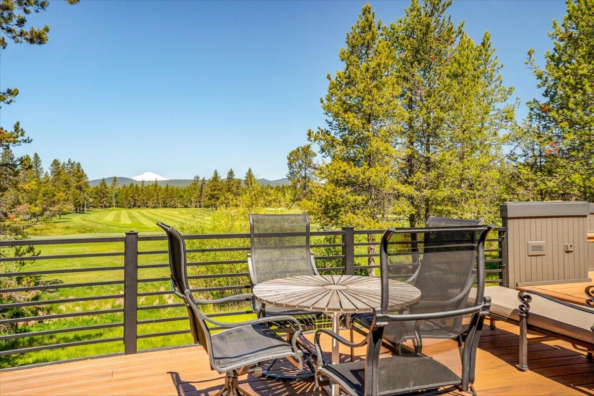 Nestled in the pine trees amidst the serene backdrop of Mt. Bachelor and the Woodlands Golf Course and ponds, this stately Sunriver retreat offers some of the community's most panoramic views. Crafted by renowned designer Don Mackprang and Sound Construction, the home boasts an open layout with rich wood flooring, elegant Ochocco Stone fireplaces, and a seamless flow of indoor-outdoor living spaces perfect for entertaining or tranquil relaxation. Enjoy the sunset vistas from the elevated deck or unwind in the hot tub, all within a generous .69-acre setting. Featuring two lavish primary suites, guest accommodations, and a versatile lower level with a family room, kitchenette, sauna, and game room. Its the perfect basecamp for all Central Oregon activities. New exterior paint and decks refinished Spring 2024!