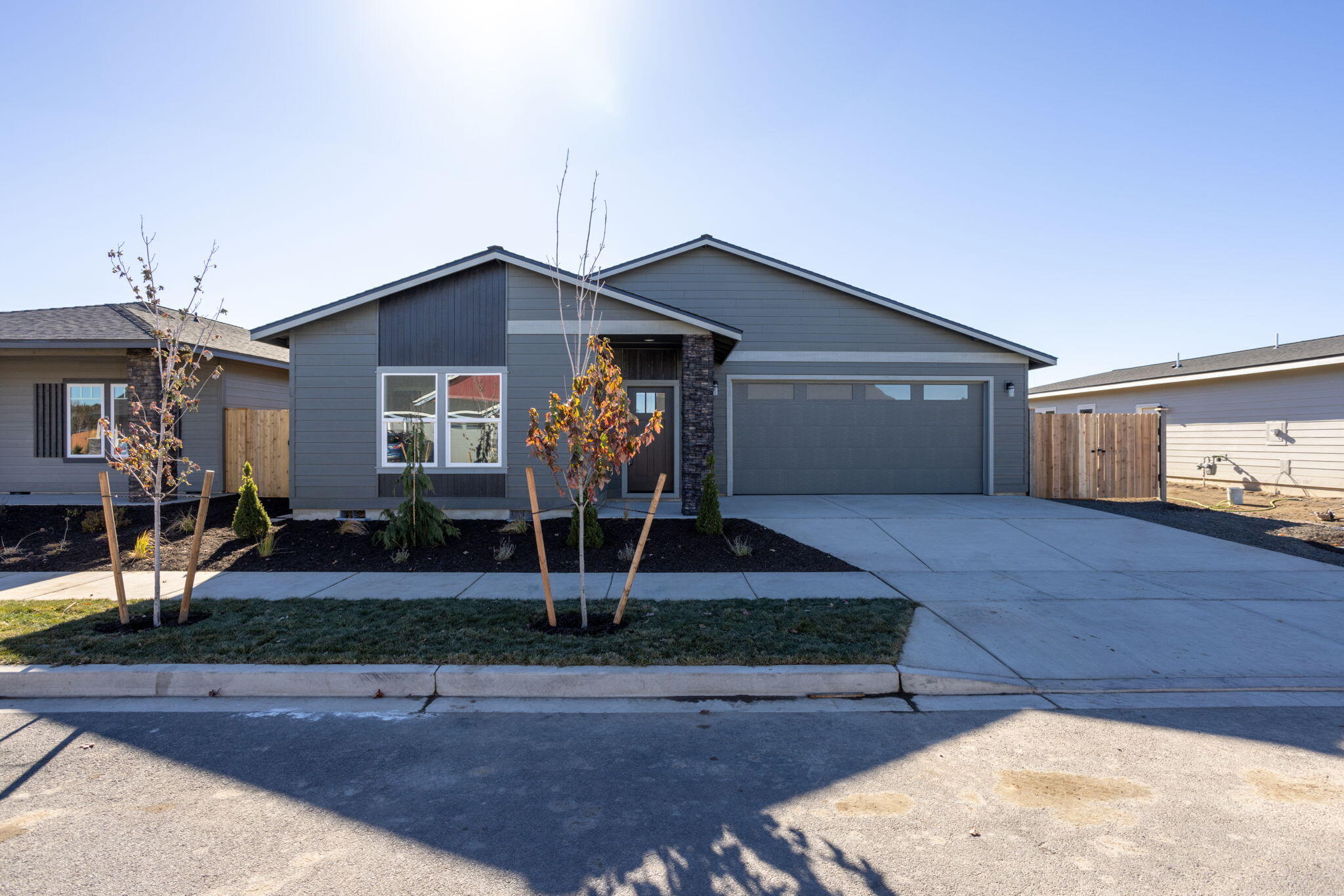 Completed & Move-In Ready! Lot 28 features the Cascade floorplan w/ 3 bdrms, 2 baths and spacious 3 car (tandem) garage. Primary bdrm features large walk-in closet, bathroom w/ 2 vanities, quartz counters, full tile backsplash, tile shower walls & enclosed toilet. Great separation between primary & 2 guest bdrms w/ full bath. Entertain in your kitchen w/ SS appliances, hidden walk-in pantry, full height tiled backsplash, extensive slab quartz countertops, soft-close cabinets & large bkfst bar island opening to vaulted dining area & great room w/ decorative gas burning fireplace. Durable laminate plank flooring thru-out w/ carpeted bdrms. Laundry/utility room too. Fenced backyard w/ landscaping & sprinklers, covered back patio. Wide side yard w/ entrance gate for toys/boat/RV parking.Upgraded finishes, A/C & tankless water heater included! *Rendering/floorplan subject to change.