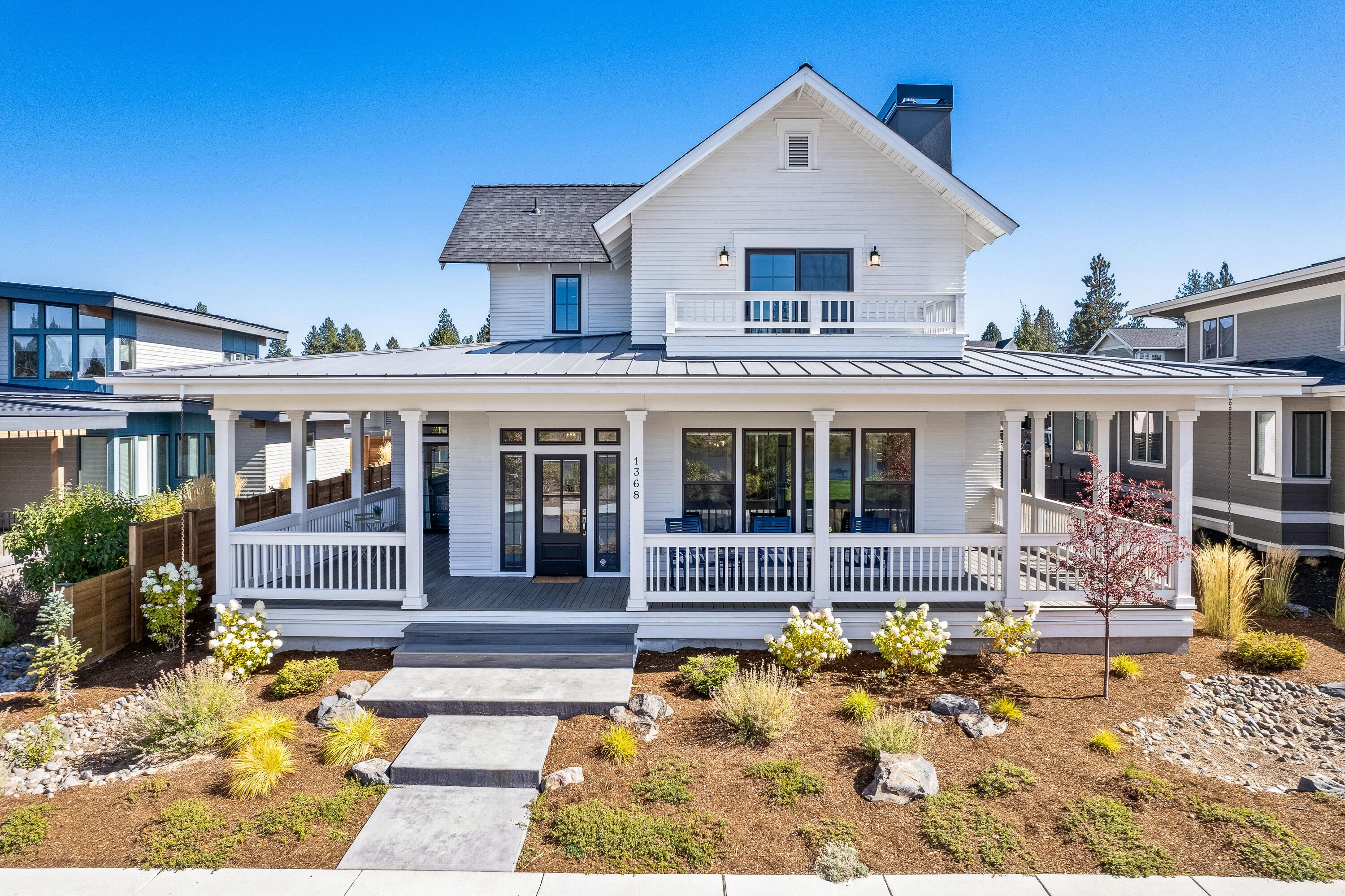 Welcome home to this absolutely dreamy modern farmhouse tucked along one of the most desirable streets in all of NW Bend directly across from the lake at Discovery Park. As you approach this home you are greeted by a welcoming wrap around front porch perfect for relaxing and taking in all of the sights. As you enter this well-planned design with warm farmhouse touches you immediately feel at home. The kitchen is the heart of this home and features custom cabinetry, gorgeous marble counters, stainless appliances w/ direct access to the front porch and back yard for entertaining in all seasons. The primary suite is on the main level and features a curb-less tile shower, double vanity and walk-in closet. Office and laundry are on the main level as well. Upstairs is a large bonus room with great views of the park and lake. 2 add'l bedrooms, a full bath w/ space to add a 2nd bath if desired. Just blocks away from the center of NorthWest Crossing, restaurants, schools, trails and more.
