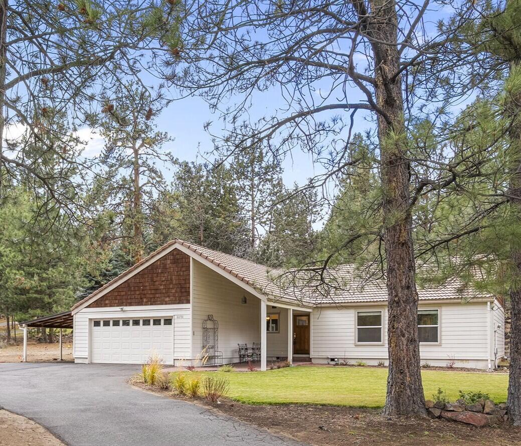 Discover a rare in-town gem on nearly half an acre—where charm, privacy, and Central Oregon living meet. This beautifully crafted 3-bed, 2-bath home welcomes you with soaring vaulted cedar ceilings, warm natural light from skylights, and a cozy gas fireplace. The open kitchen shines with granite countertops, stainless steel appliances, and a tankless water heater. Retreat to the primary suite featuring French doors that lead to an expansive Trex deck—your go-to spot for slow mornings or sunset gatherings. The timeless Spanish tile roof adds striking curb appeal, while the .48-acre corner lot offers endless possibilities: greenhouse, RV parking, toy storage, or future projects. All this, just minutes from schools, golf, and everyday conveniences. A true blend of comfort, character, and space.