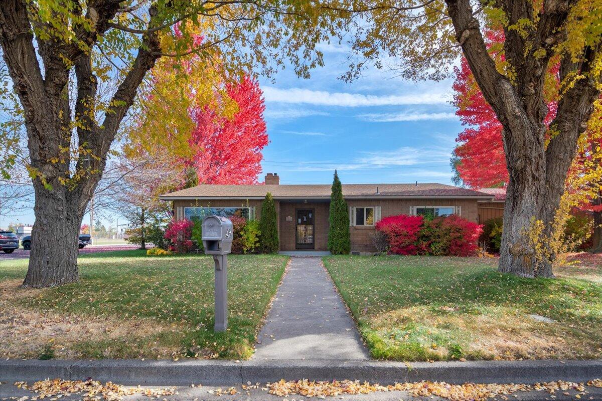 Set on a beautiful corner lot across from the school, this single-level home is tucked into a surprisingly quiet neighborhood surrounded by mature trees that come alive with color in the fall. Inside, the ranch-style layout offers a spacious and thoughtful flow, including a generous primary suite and multiple living areas that showcase the solid craftsmanship of its era. With alley access to the garage and carport, plus a small enclosed area perfect for RV, boat, or trailer storage, this home is as functional as it is full of potential. A perfect opportunity for someone ready to bring fresh style and modern updates to a home with great bones and timeless structure.