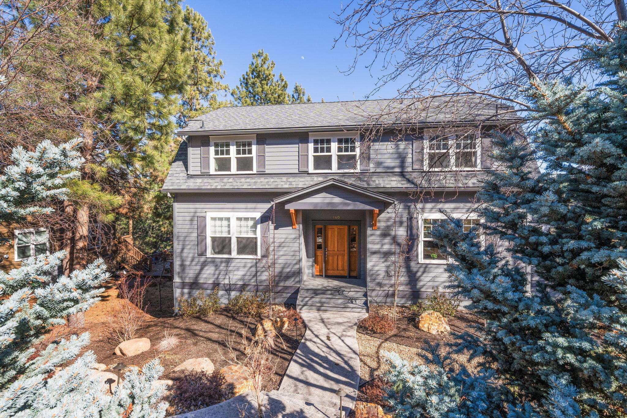 Nestled in the established and highly desirable Miller Heights neighborhood, this beautifully updated home offers the perfect blend of modern convenience and timeless charm. The thoughtfully renovated kitchen features quartz counters, ceiling-height cabinets, and new Thermador appliances. The primary suite on the main level boasts a fireplace and updated ensuite bath with tiled shower, soaking tub, and walk-in closet. Upstairs are 3 additional bedrooms, including a junior suite, an office and a bonus room. The oversized 3-garage can handle all of your gear and includes a workout room or shop area. Multiple Trex decks and a flat backyard provide endless options for entertaining and relaxing. Enjoy quick access to outdoor recreation, highly rated schools, and west side amenities - 0.2 mile from the 40 acre Overturf Park and just a few easy blocks to the vibrant Galveston Corridor. Major mechanicals are new, including roof, water heater, furnace and A/C.  This is Bend living at its best!