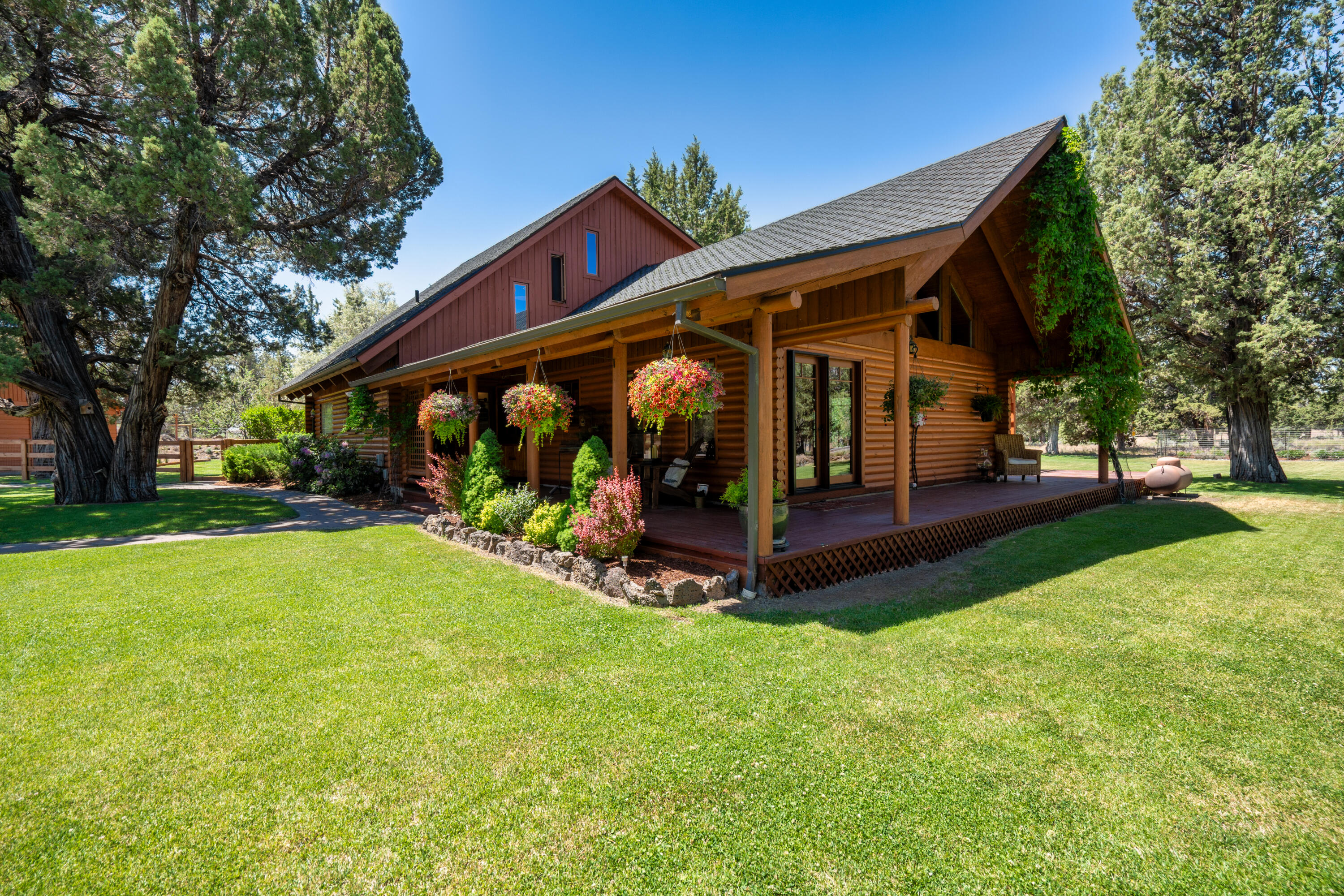 Welcome to this stunning log cabin, offering over 2,000 sq ft of living space on more than 2 acres along with beautifully landscaped grounds. This home seamlessly blends rustic charm with modern amenities, featuring new appliances, custom-made hardwood floors, and expansive windows. With 3 bedrooms, 3 baths, and high ceilings, the interior is spacious and inviting. Multiple entertaining areas, including a family entertaining room and numerous balconies, provide the perfect setting for gatherings.
Step outside to enjoy finished landscaping, a soothing water feature, and a luxurious jacuzzi tub. The property is fenced for privacy and boasts an oversized 3-car garage with ample storage, RV parking with 50 amps service and RV dump and a circular driveway for easy access. Located on a corner lot, this home offers both seclusion and convenience. Whether you're hosting guests or seeking a peaceful retreat, this cabin has it all. Don't miss your chance to own this exceptional property!