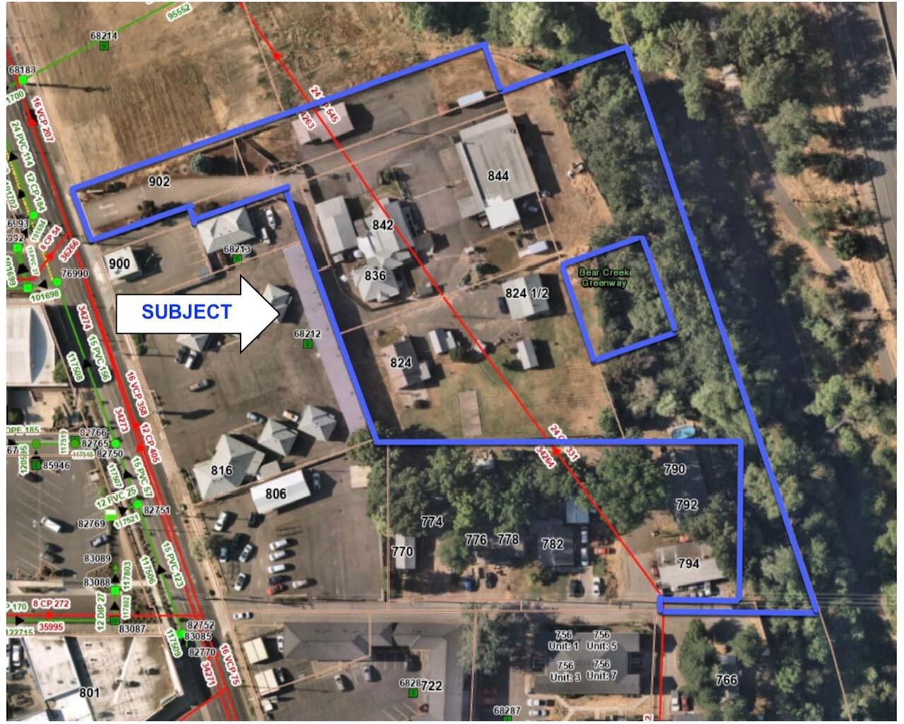 Zoned C-C (Community Commercial), this property offers a wide range of permitted uses, including multi-family residential development (MFR-30). The site is currently improved with a mixed-use facility consisting of the following structures: A 3,464 sq. ft. light industrial shop; 3 single-family residences; 2 single-car detached garages; One four-car detached garage; One attached four-car tandem garage. Improvements were constructed between 1948 and 1998 and are of wood-frame construction. Site enhancements include asphalt and concrete paving, perimeter fencing, and multiple storage sheds. The property spans six tax lots, comprising a total of 2.90 acres (126,324 sq. ft.). Of this, the net developable area is 1.98 acres (86,314 sq. ft.). Tax Parcels included are: 10703644, 10328558, 10328614,10328517, 10328541, 10328566.  Site addresses: 824-902 N Riverside Ave., Medford.