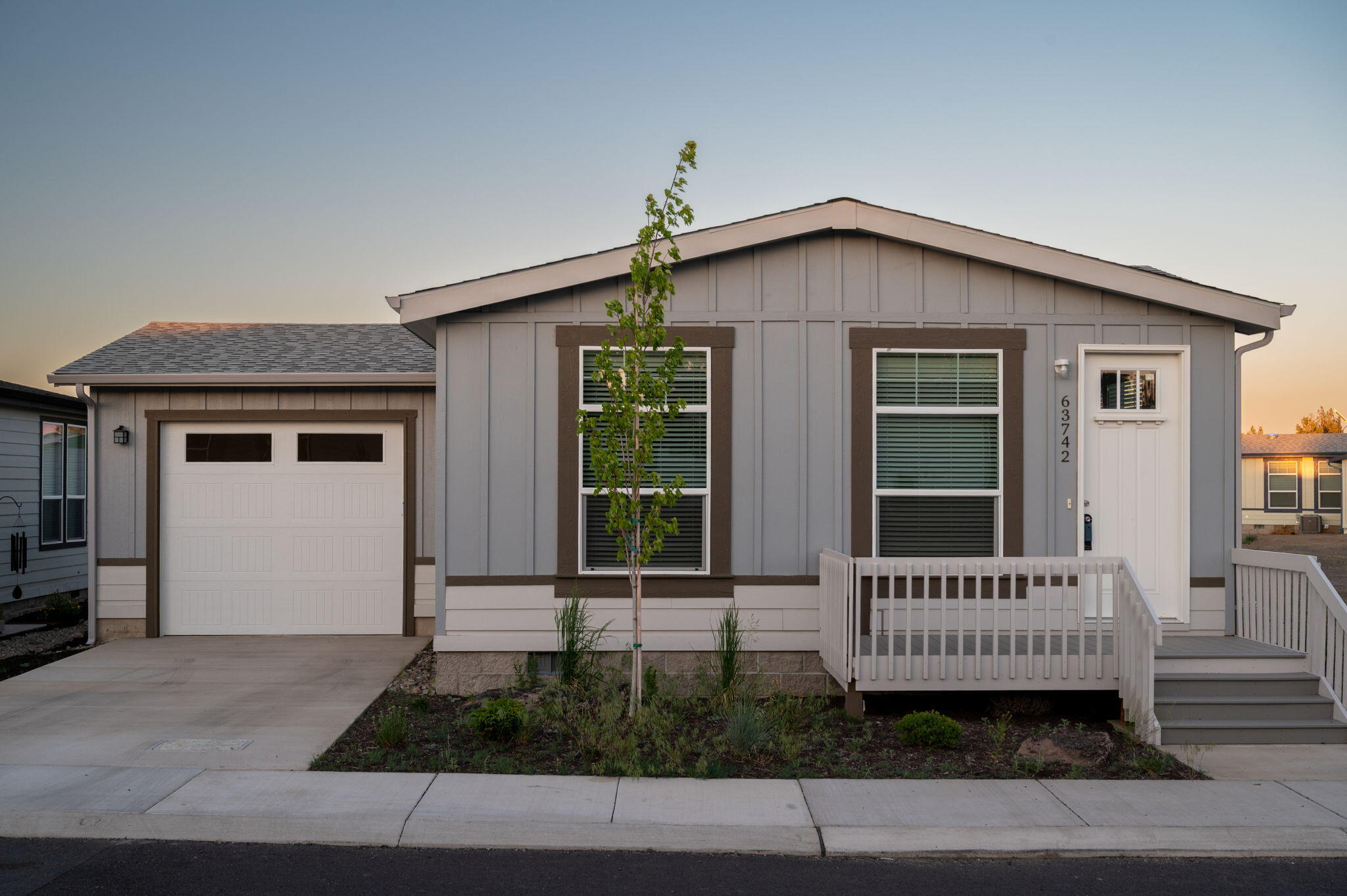 Welcome to Cascade Village, Bend's premier 55+ manufactured home community. Step inside your dream home, the Pine Grove model, a perfect blend of modern design and cozy living. Featuring a striking 9-foot ceiling and an attached single-car garage, this residence effortlessly combines style and functionality. The heart of this home is the beautifully appointed kitchen, featuring a stainless steel appliance package and a charming farmhouse sink. This beautifully designed home is not just a place to live; it's a sanctuary that combines comfort, style, and efficiency for modern living. Experience the exceptional lifestyle you've always desired in this exquisite residence, where every detail has been thoughtfully crafted for your enjoyment.